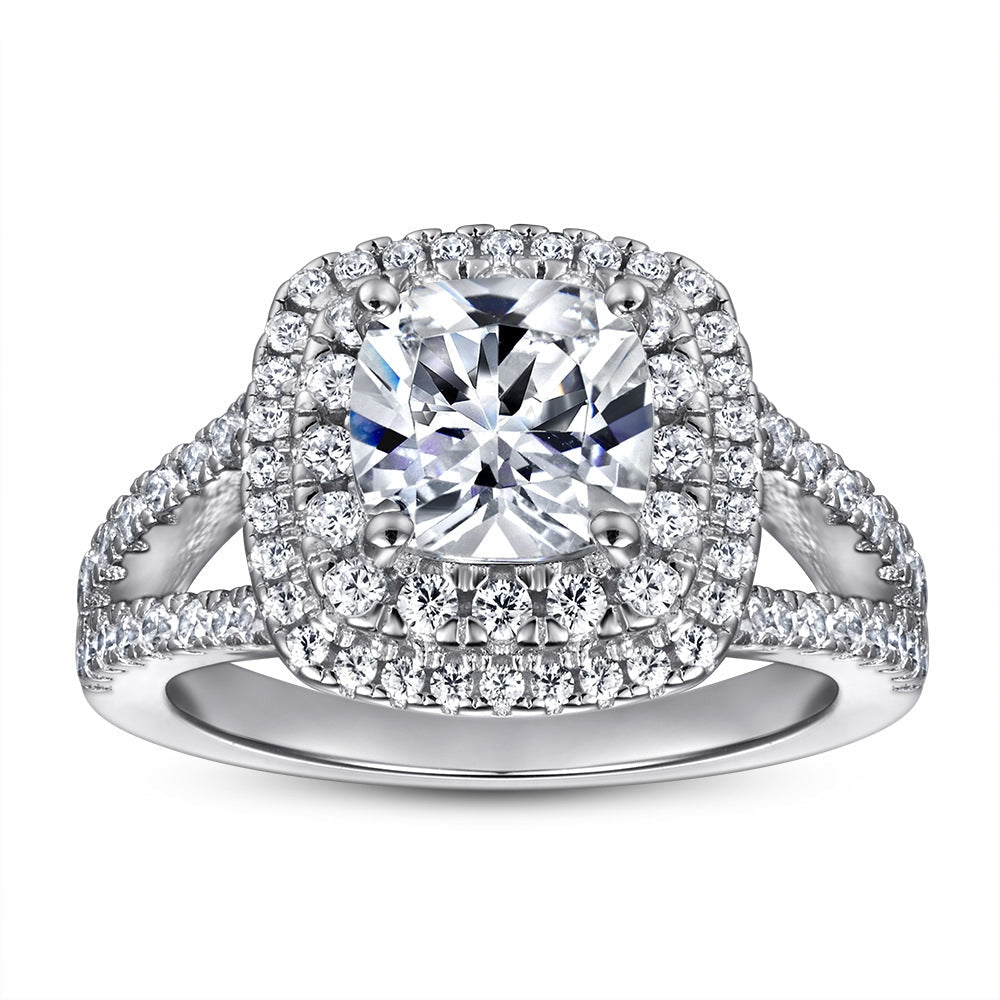 A sparkling loyalty halo ring made of 925 sterling silver with a white sapphire centerpiece, showcasing a luxurious design.