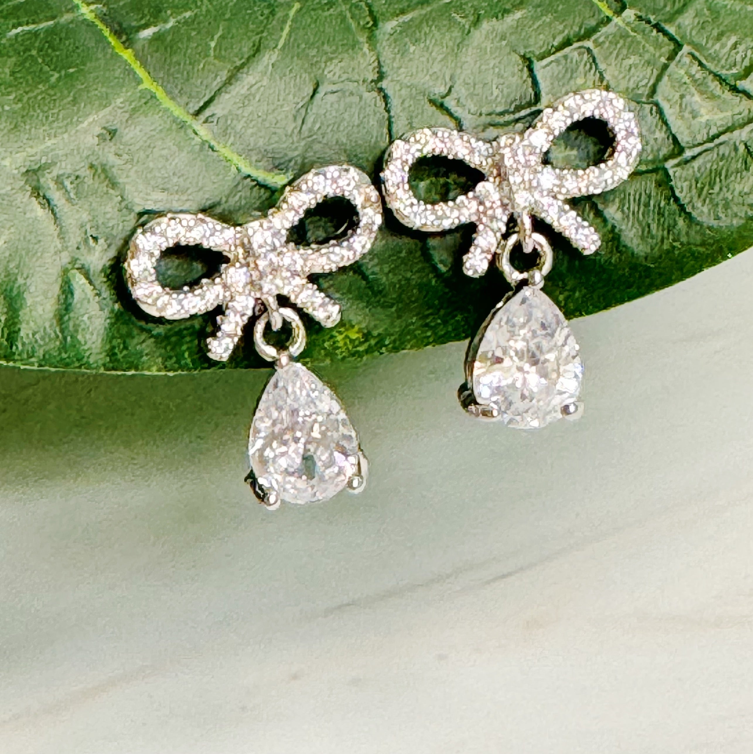 Elegant Sparkly Bow Teardrop Earrings featuring a dainty bow design with cubic zirconia stones and 18k gold plating.