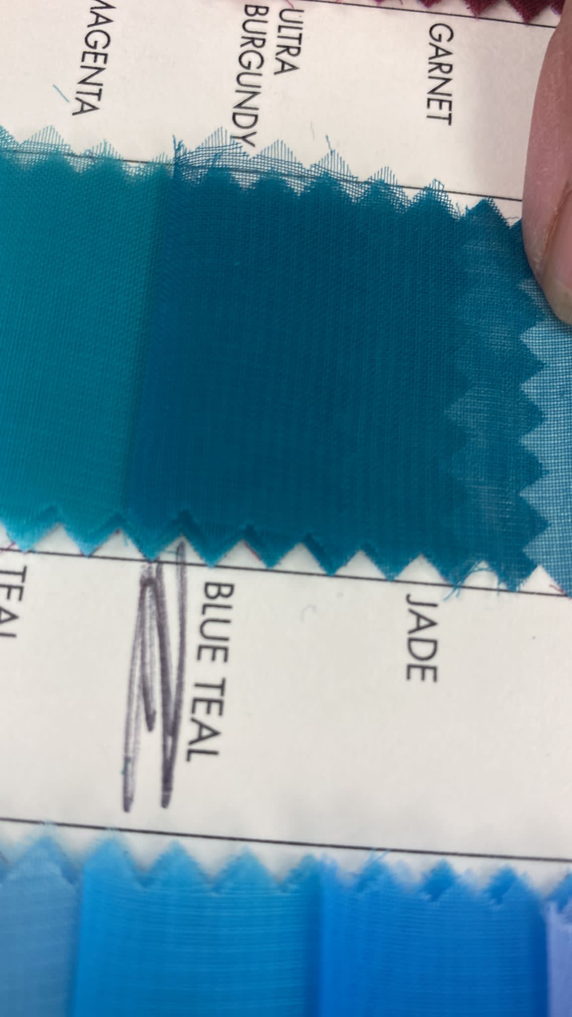 A collection of 120 handmade glass evil eye beads with gold trim and teal ribbon, showcasing their unique design and craftsmanship.