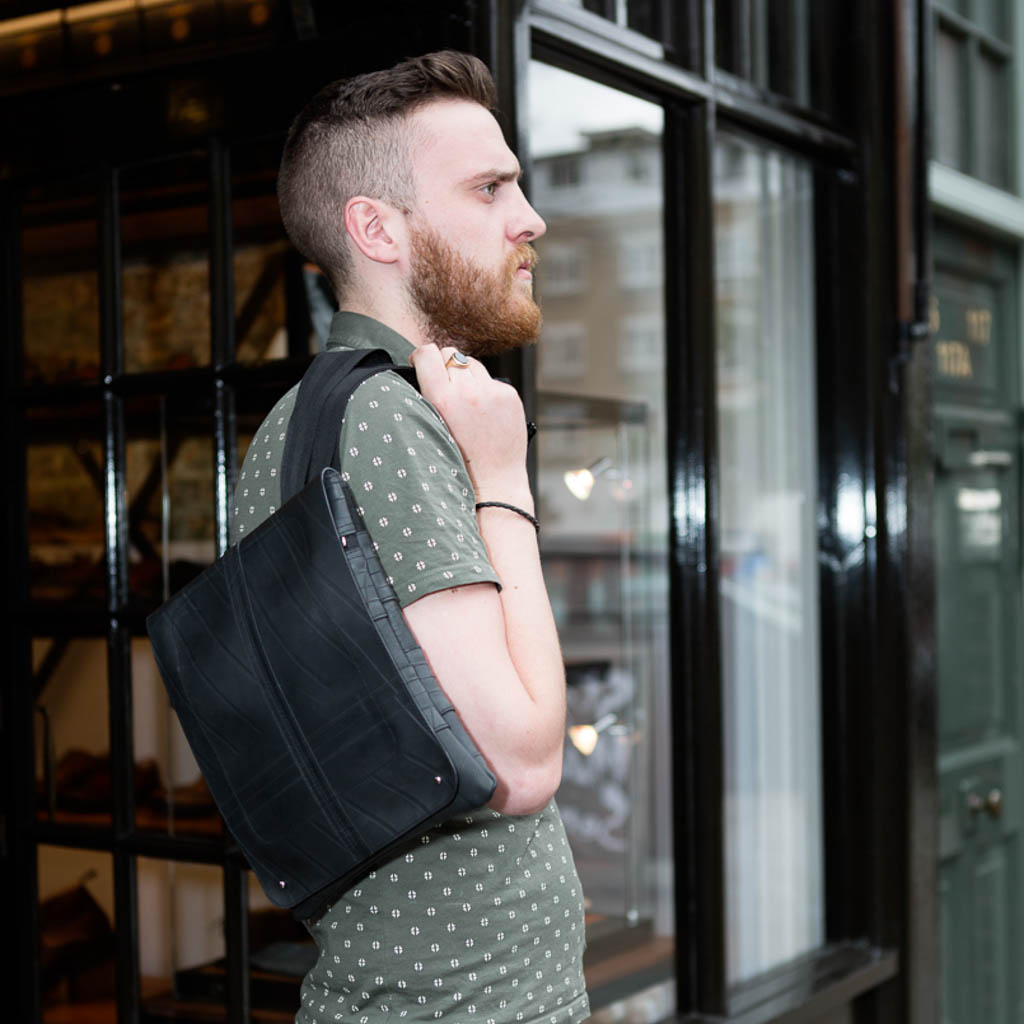 Spencer Recycled Rubber Vegan Crossbody Bag showcasing unique patterns and textures from reclaimed inner tubes, available in three sizes.