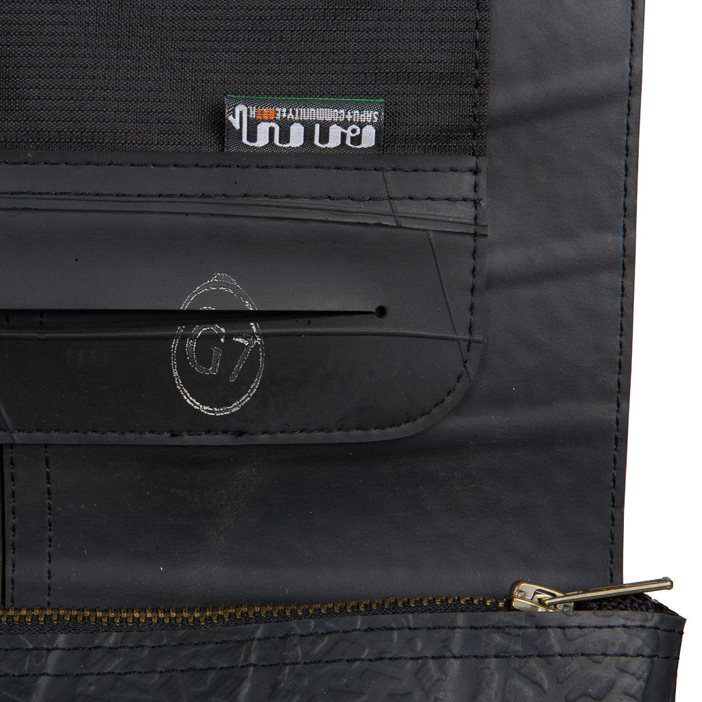 Spencer Recycled Rubber Vegan Crossbody Bag showcasing unique patterns and textures from reclaimed inner tubes, available in three sizes.