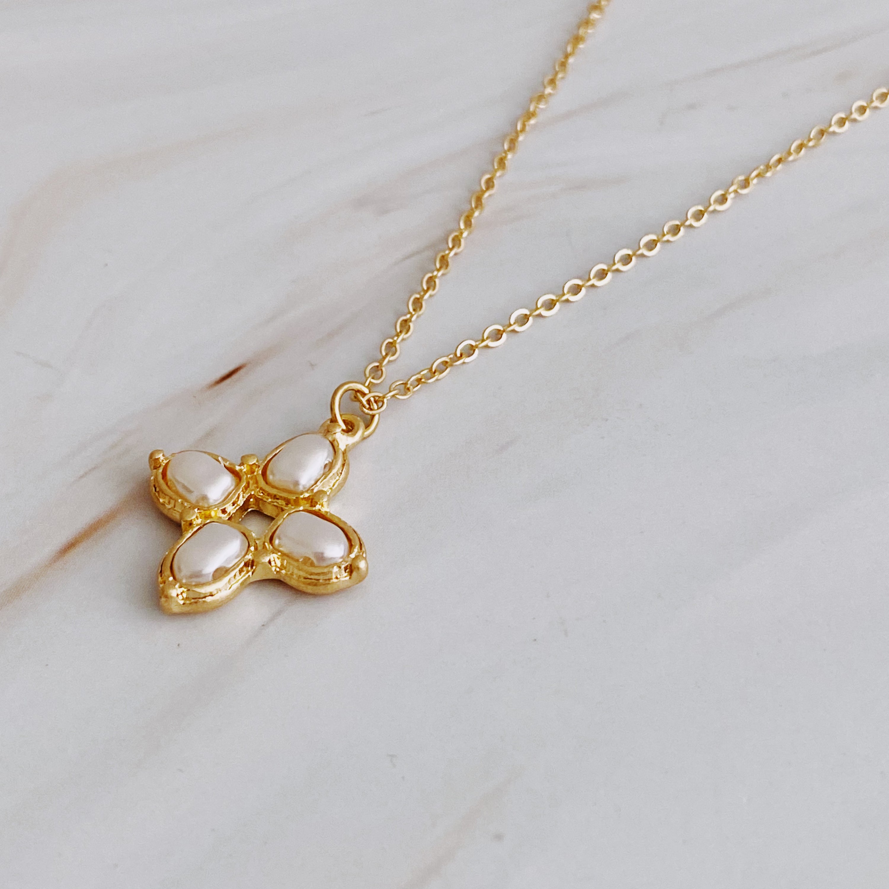 Elegant Square Pearl Cross Necklace with gold plating and pearl detailing, showcasing a unique cross design.