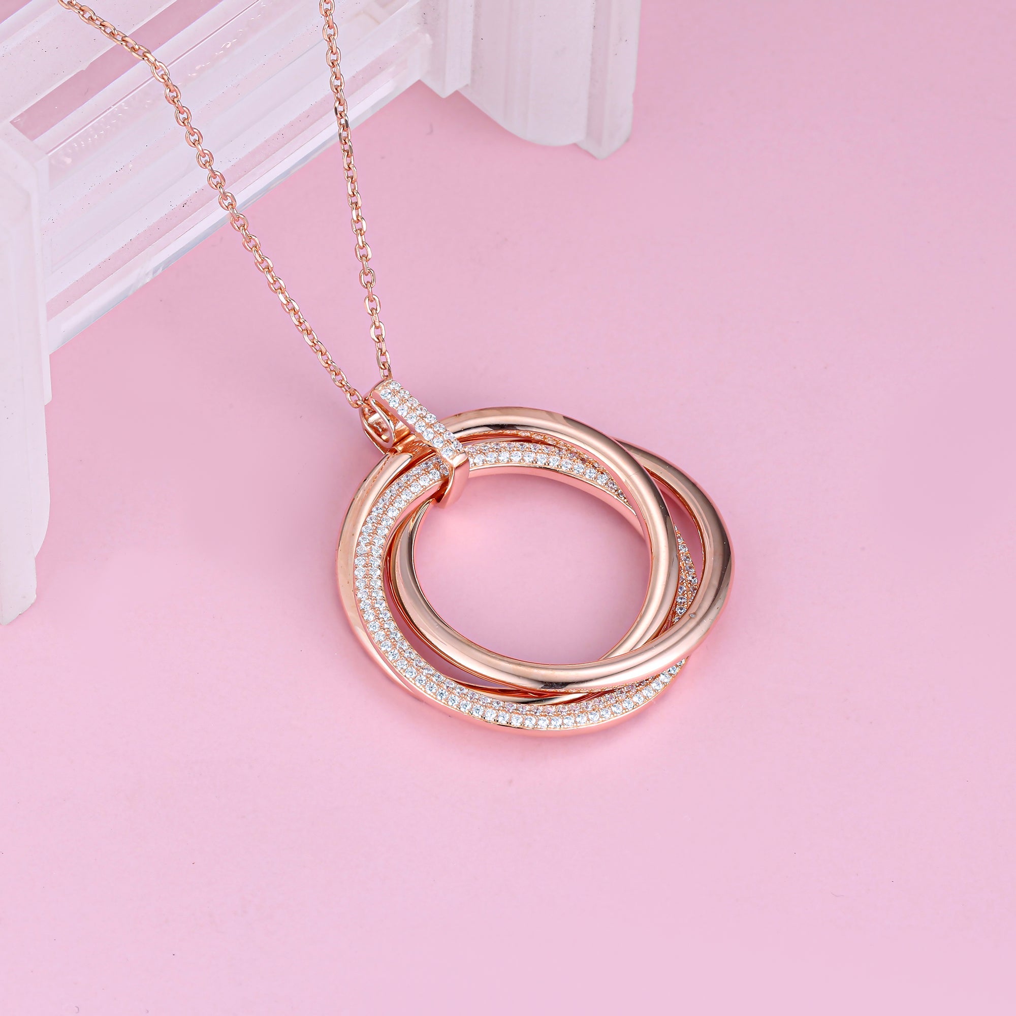 Stackable layered sterling silver necklace with cubic zirconia pendant and halo, showcasing elegance and craftsmanship.