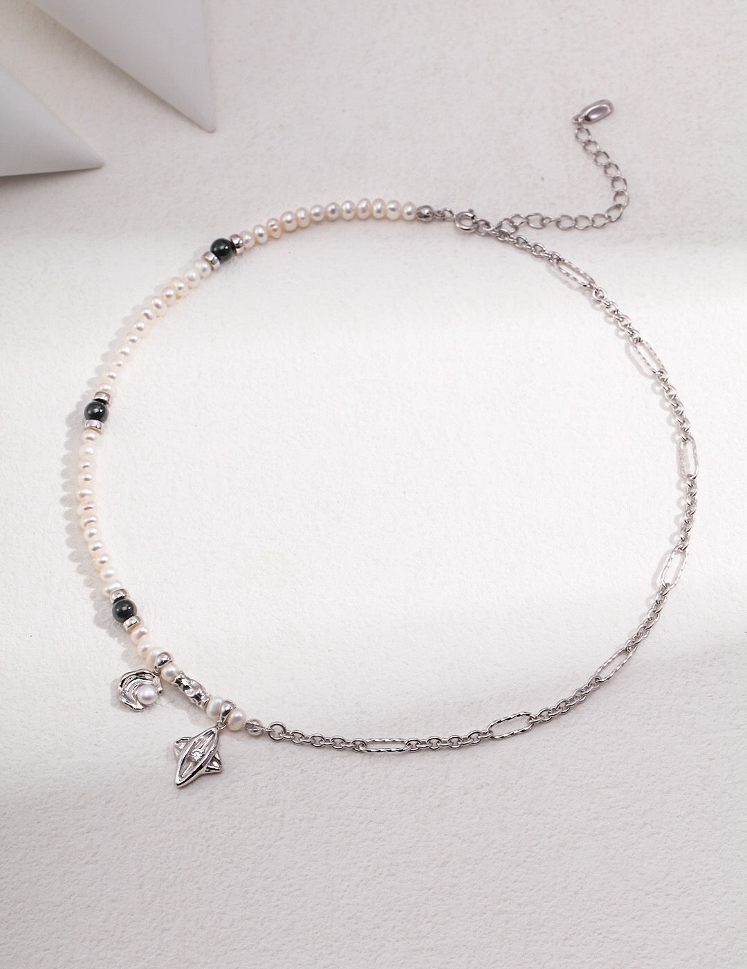 Star and Moon Design Pearl Necklace featuring natural pearls, black agate, and gold vermeil, elegantly displayed on a soft background.