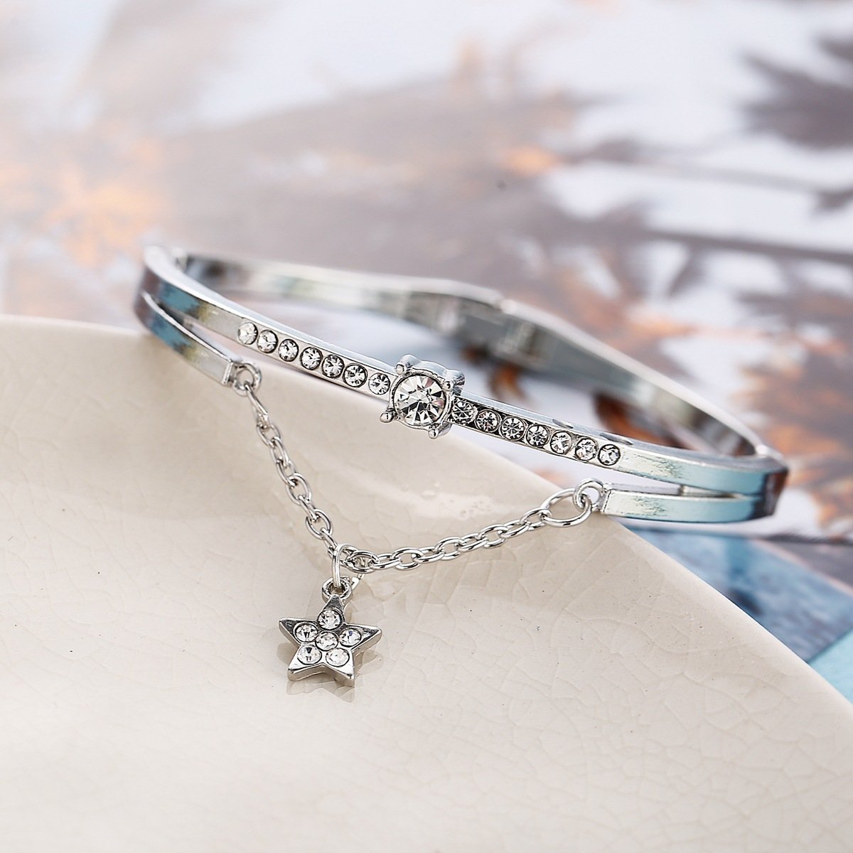 Elegant Star Drop Bracelet featuring Austrian Crystals, crafted in 18K white gold plating, showcasing a stunning design.