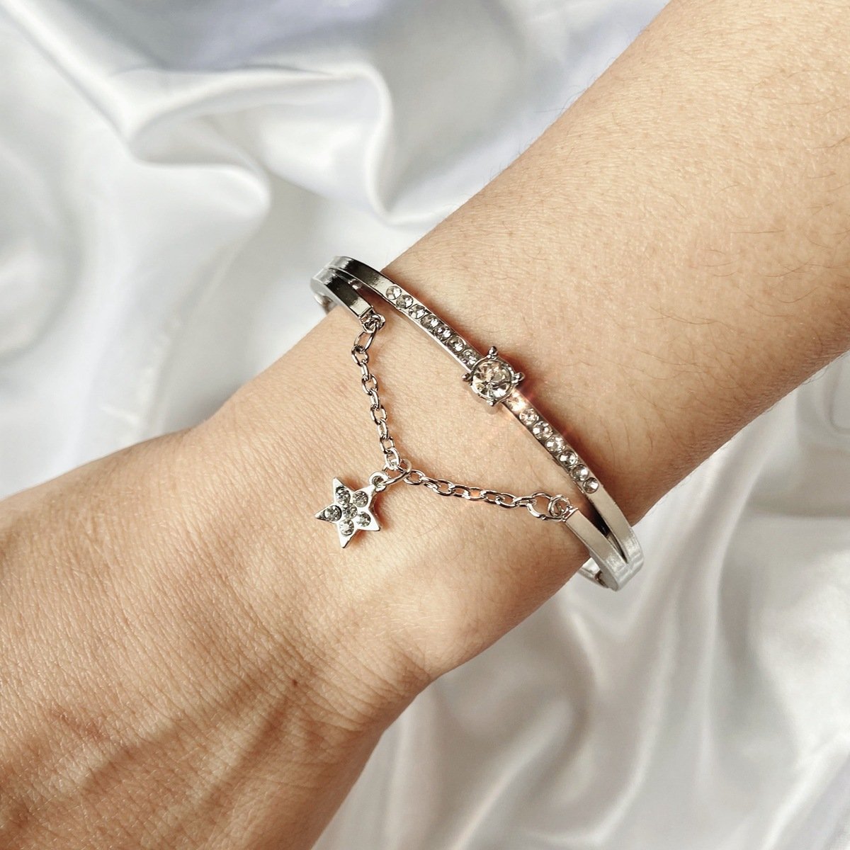 Elegant Star Drop Bracelet featuring Austrian Crystals, crafted in 18K white gold plating, showcasing a stunning design.