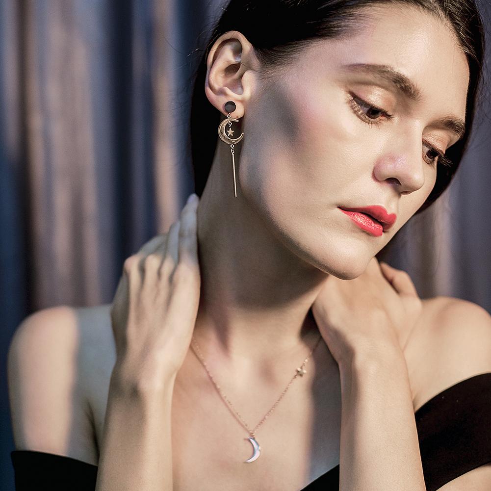 Elegant Star & Moon Long Drop Earrings made of stainless steel with gold plating, showcasing a celestial design.