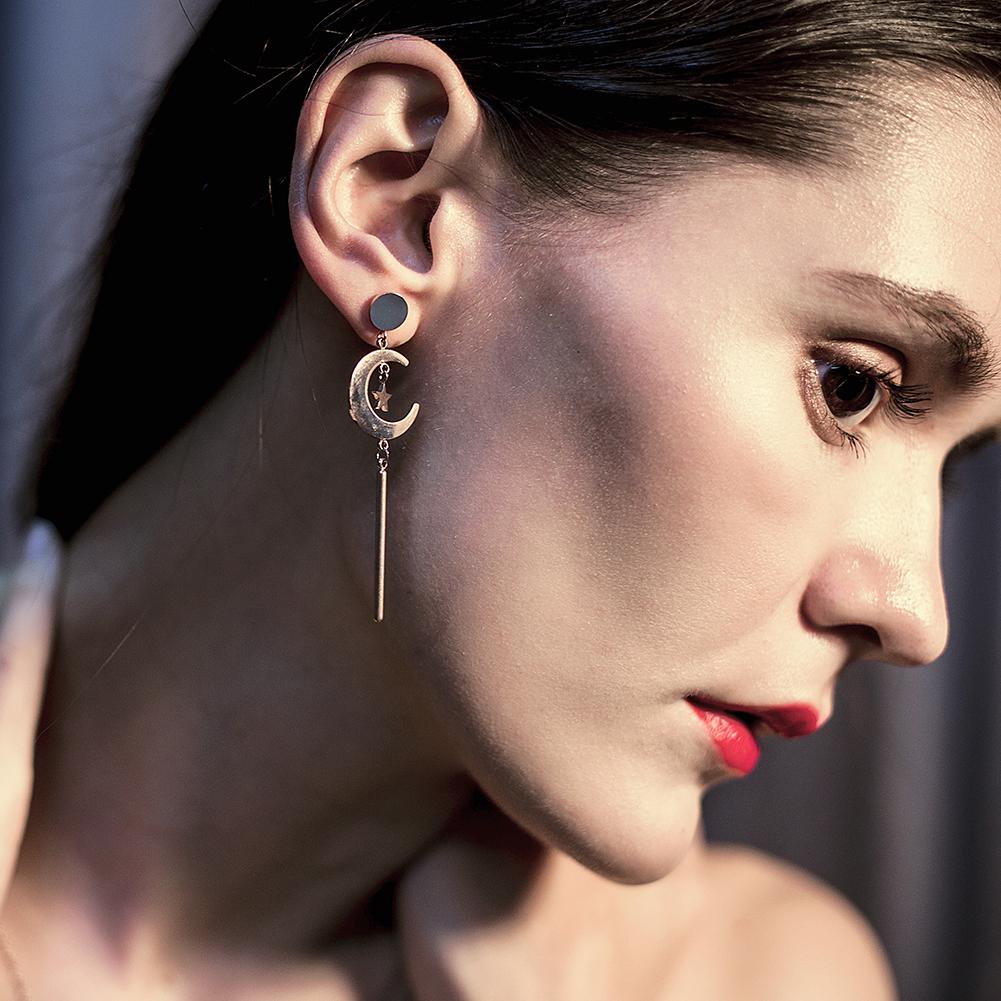 Elegant Star & Moon Long Drop Earrings made of stainless steel with gold plating, showcasing a celestial design.