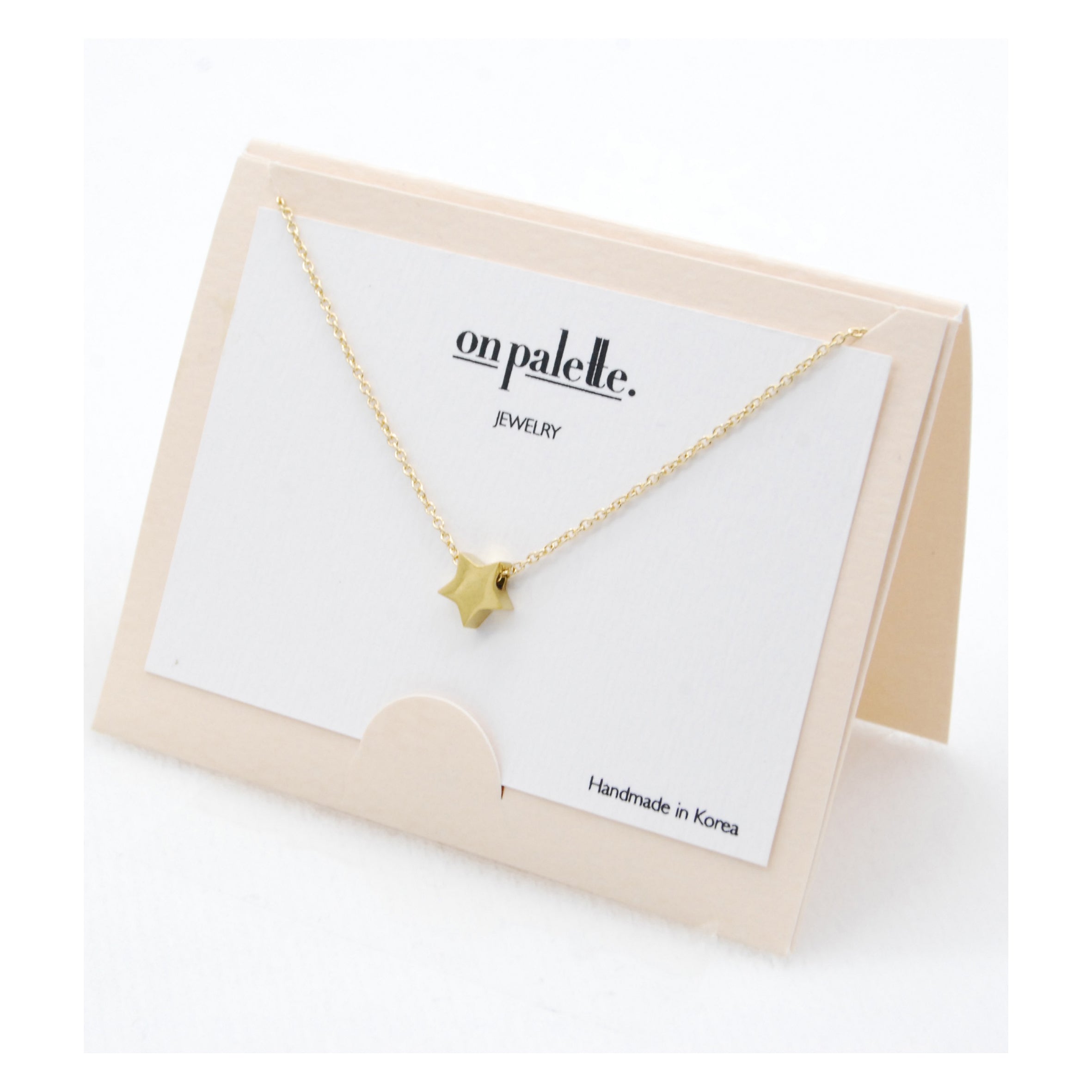 A collection of colorful Star Pendant Necklaces by DOBBI, showcasing their stainless steel craftsmanship and elegant star design.