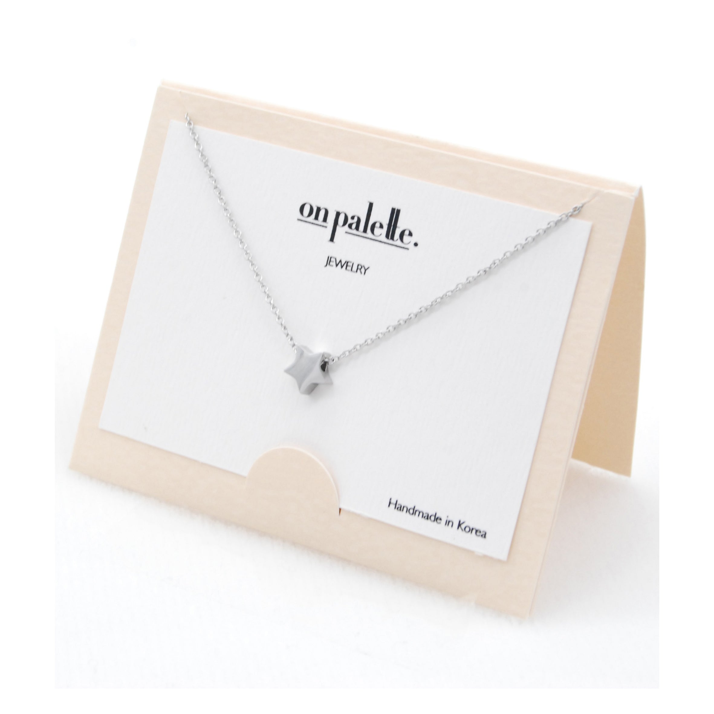 A collection of colorful Star Pendant Necklaces by DOBBI, showcasing their stainless steel craftsmanship and elegant star design.