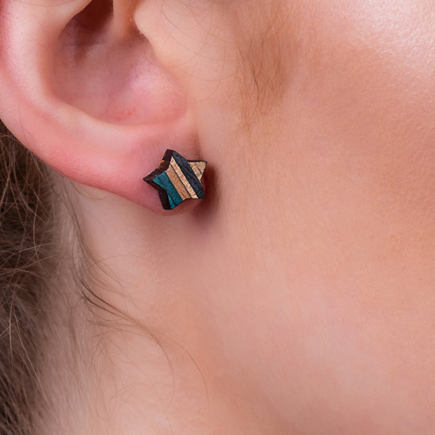 Star-shaped stud earrings made from recycled skateboard wood, showcasing vibrant colors and unique patterns.