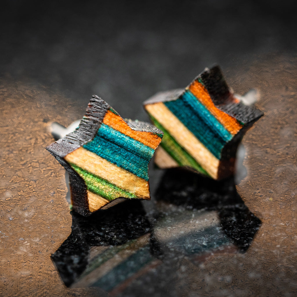 Star-shaped stud earrings made from recycled skateboard wood, showcasing vibrant colors and unique patterns.