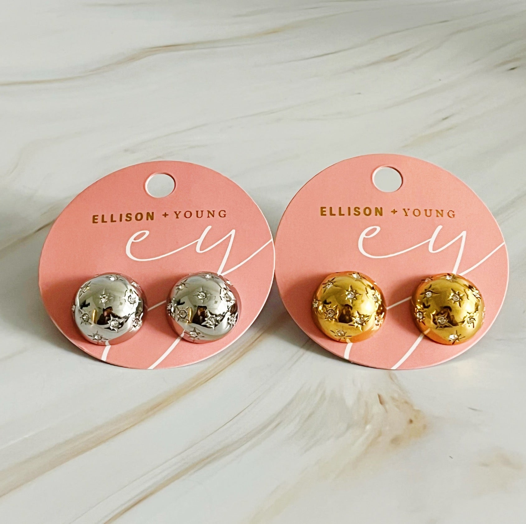 Elegant Starlight Sphere Stud Earrings in gold and silver finishes, showcasing a unique design with a sparkling shine.