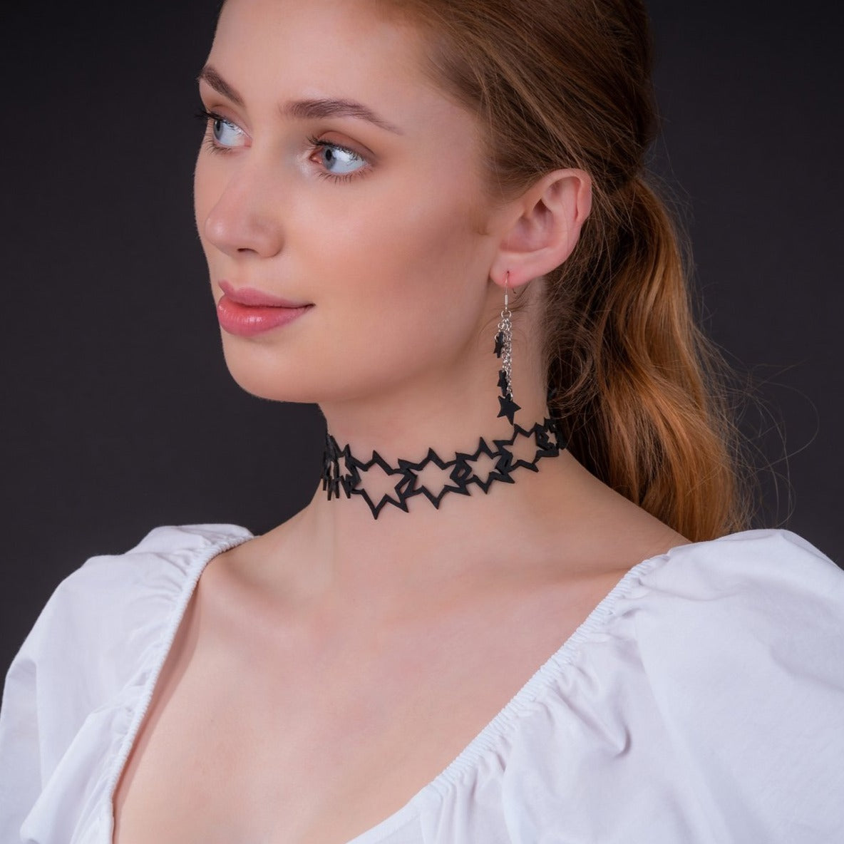 A pair of handmade Stars Eco Friendly Earrings crafted from reclaimed rubber, featuring unique textures and sterling silver hooks.