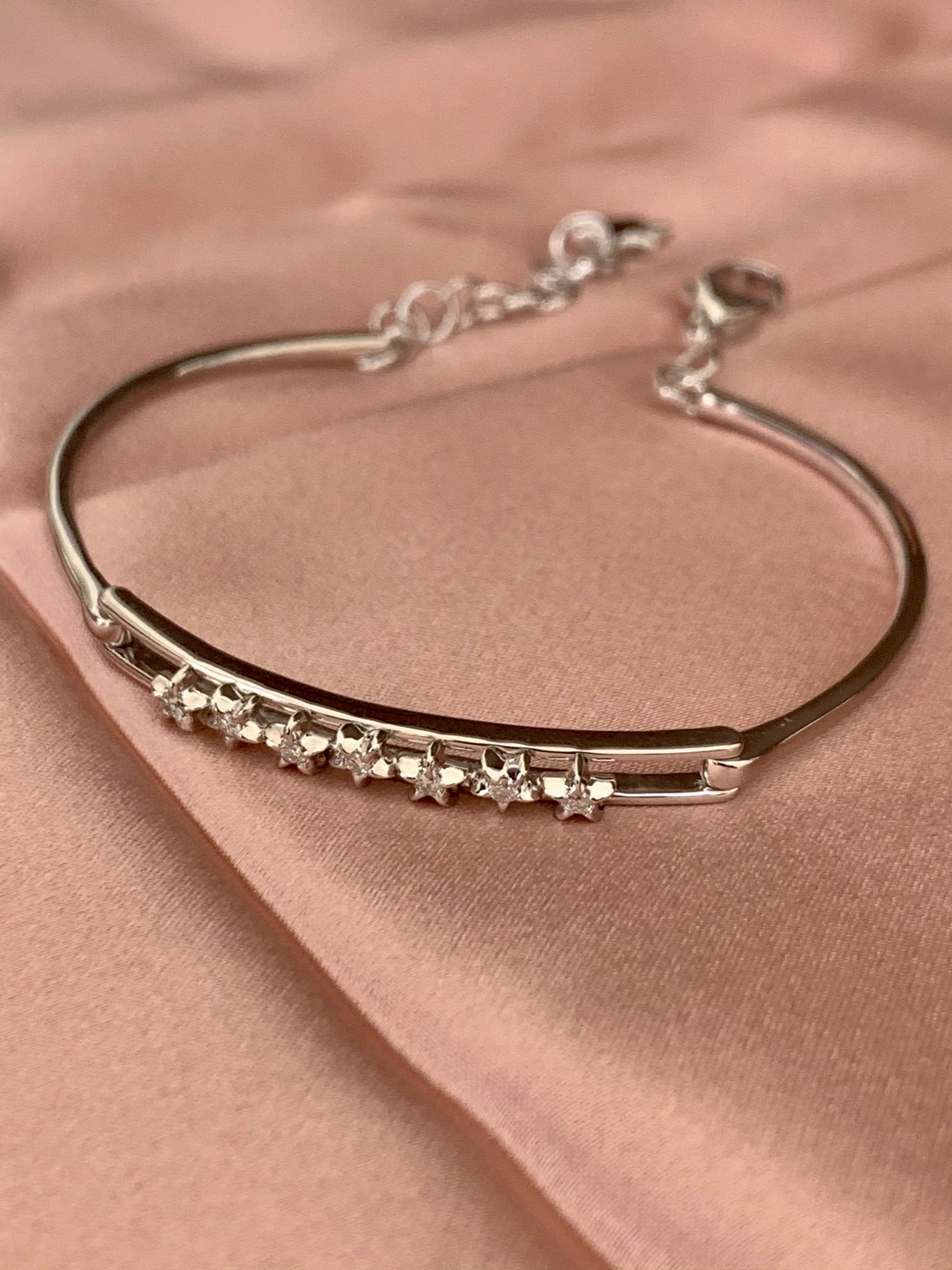 Starry Lane Diamond Bangle in Sterling Silver featuring genuine diamonds in a channel setting, adjustable chain element, and elegant design.