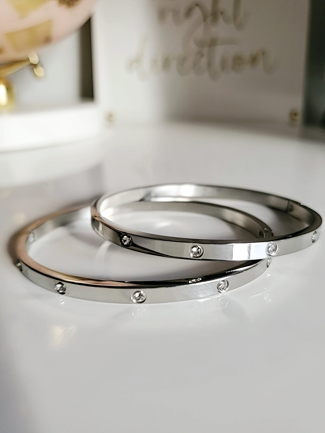 A stunning silver bangle bracelet made of 316L stainless steel, featuring simulated diamonds, showcasing a retro yet timeless design.