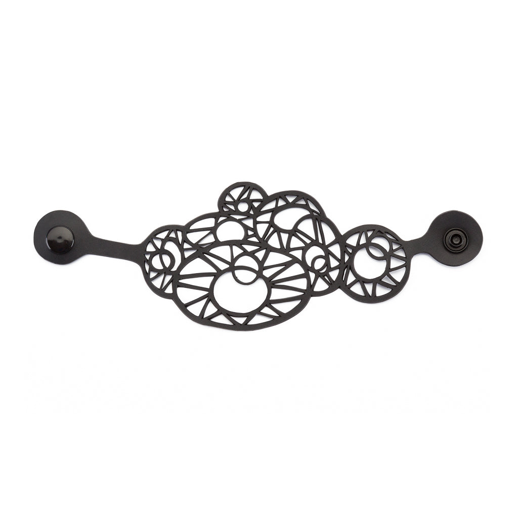 Stellar Quirky Geometric Upcycle Bracelet made from recycled rubber, featuring unique geometric shapes and a plastic button clasp.