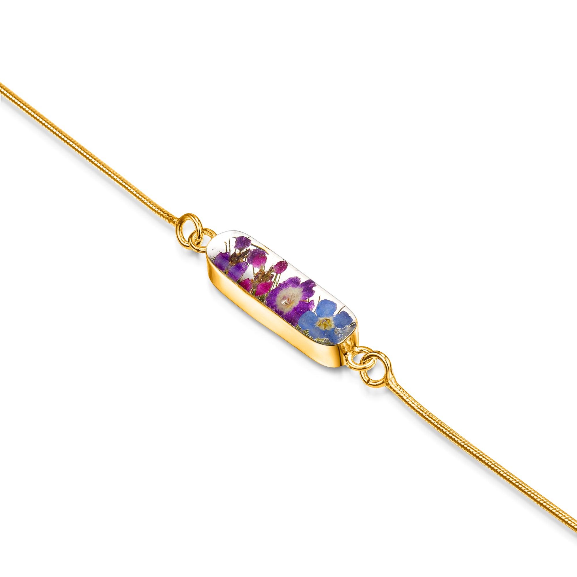 Sterling silver anti-tarnish snake bracelet featuring tiny purple flowers and a flower charm, elegantly displayed in a gift box.