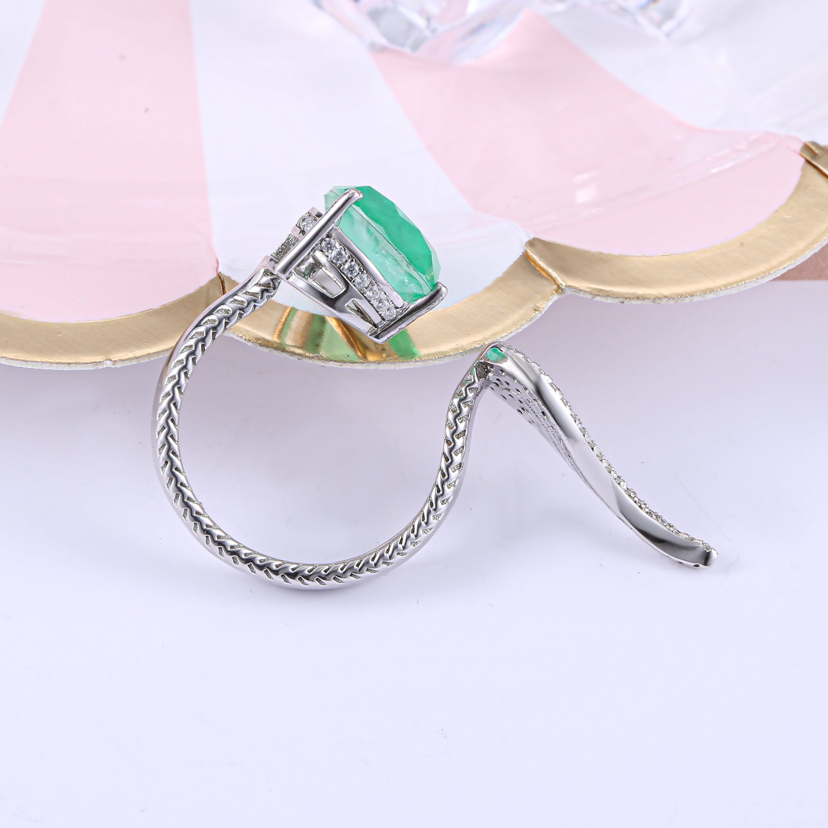 Sterling silver feather open ring with white sapphire, showcasing intricate design and real white gold finish.