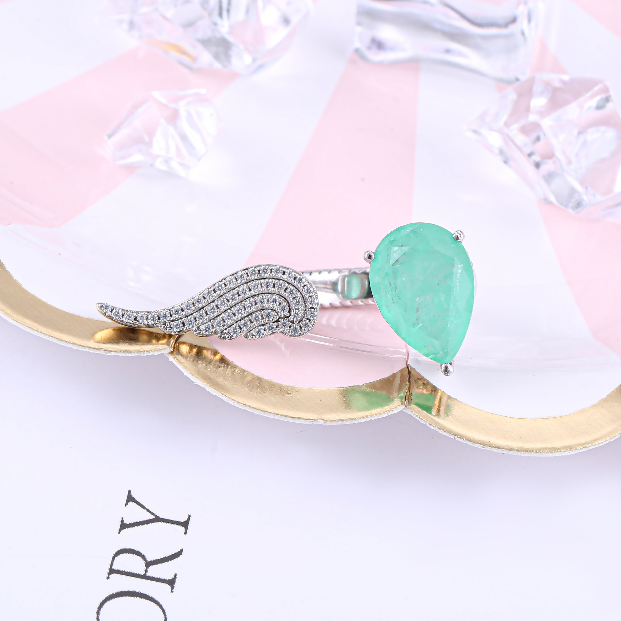 Sterling silver feather open ring with white sapphire, showcasing intricate design and real white gold finish.