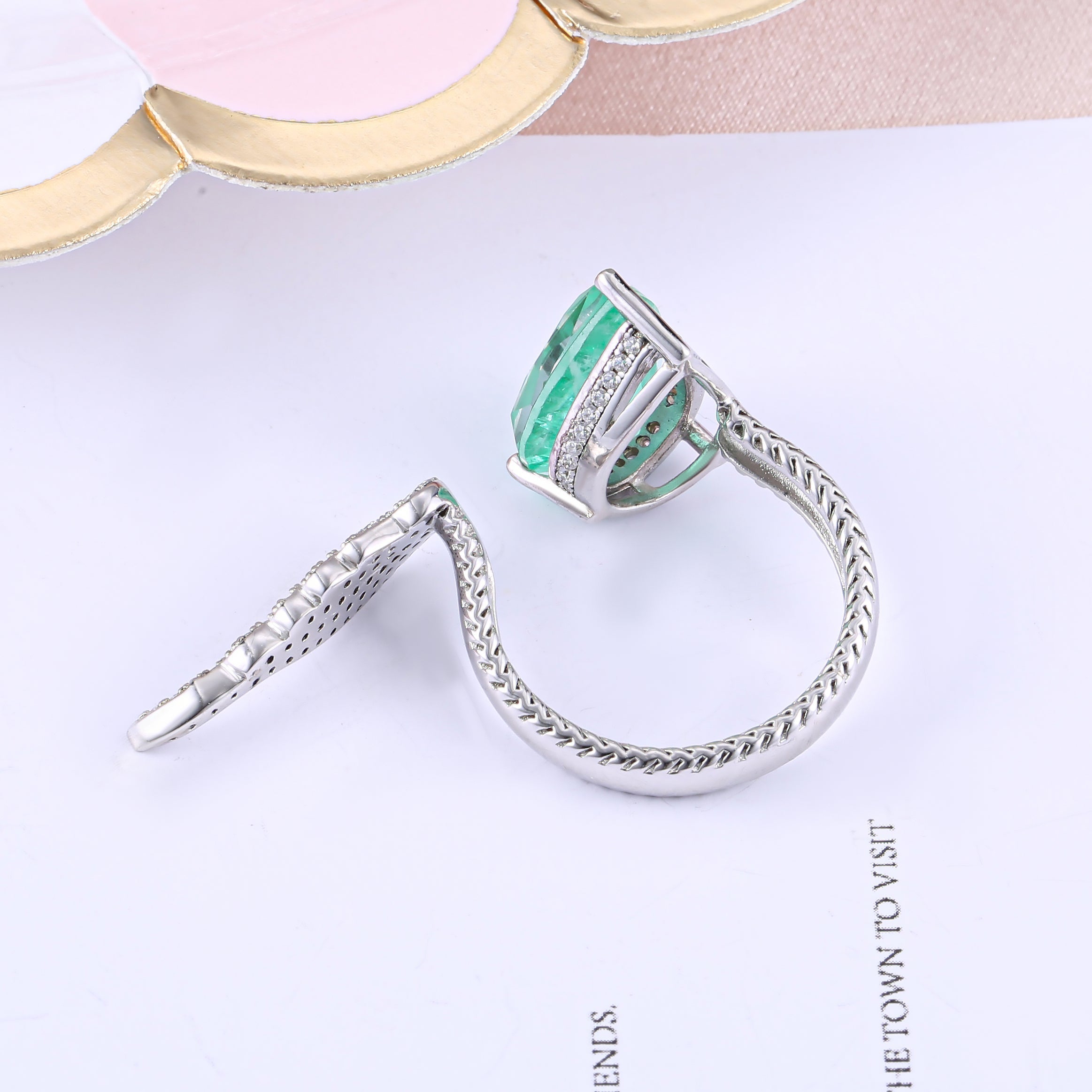 Sterling silver feather open ring with white sapphire, showcasing intricate design and real white gold finish.