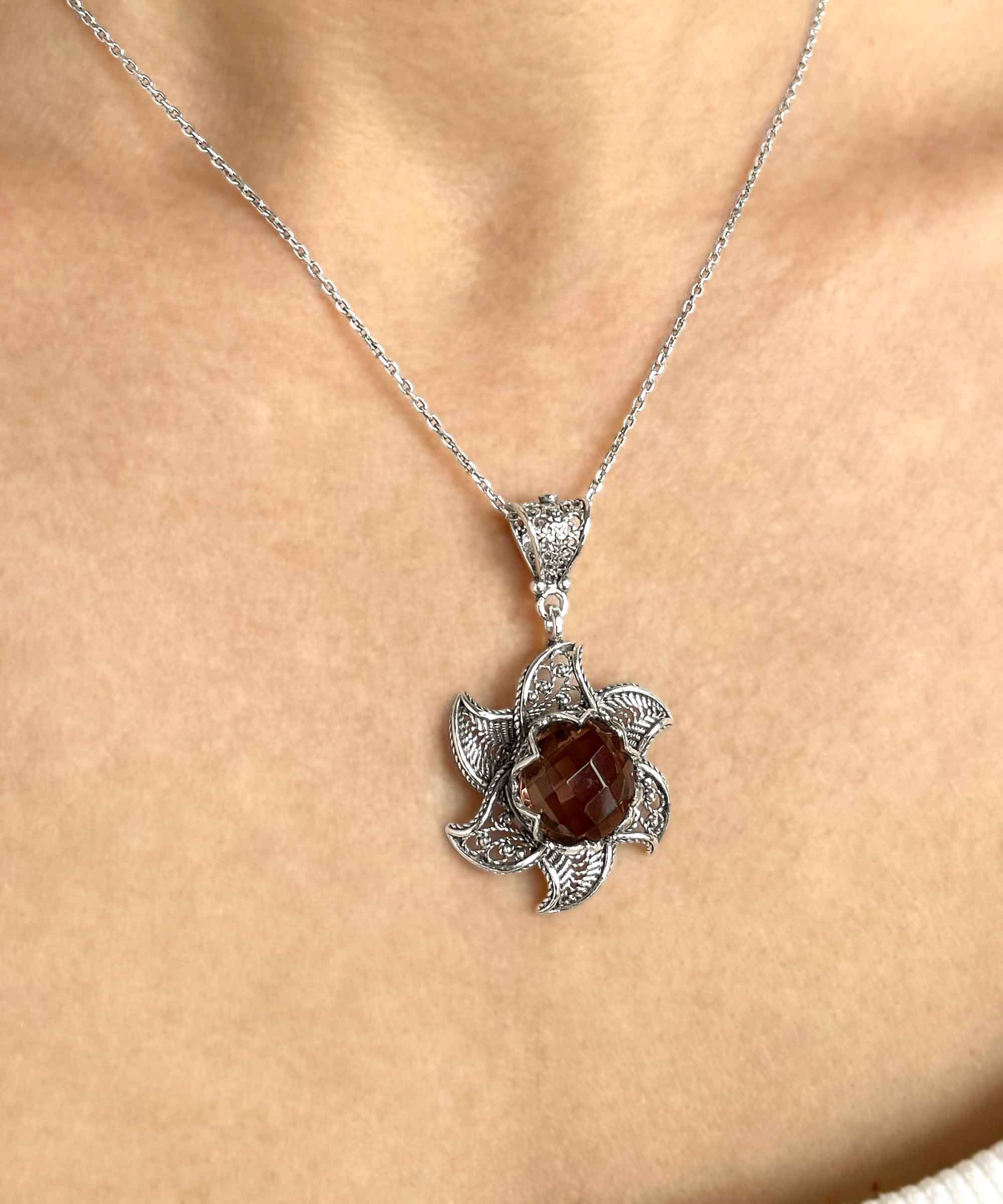 Sterling Silver Filigree Alexandrite Gemstone Blossoming Lotus Flower pendant with intricate design and vibrant gemstone.