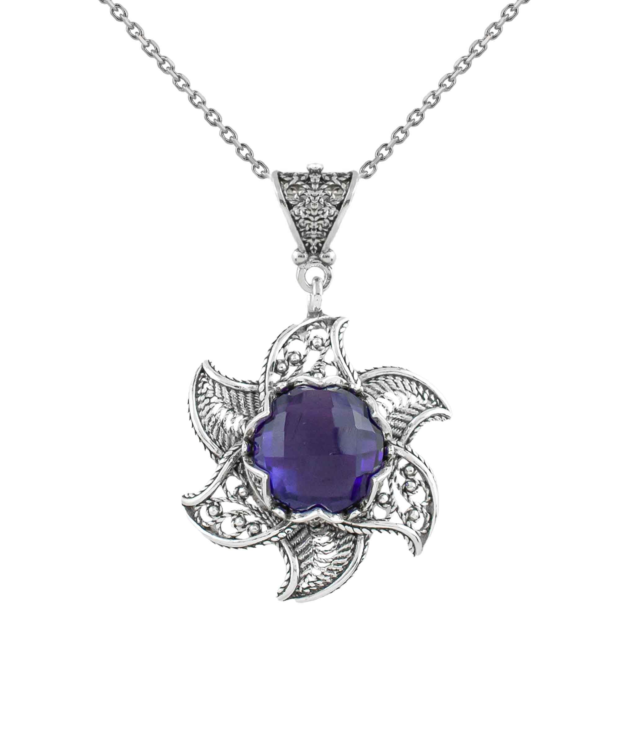 Sterling silver filigree lotus flower pendant with amethyst gemstone, elegantly designed and polished.