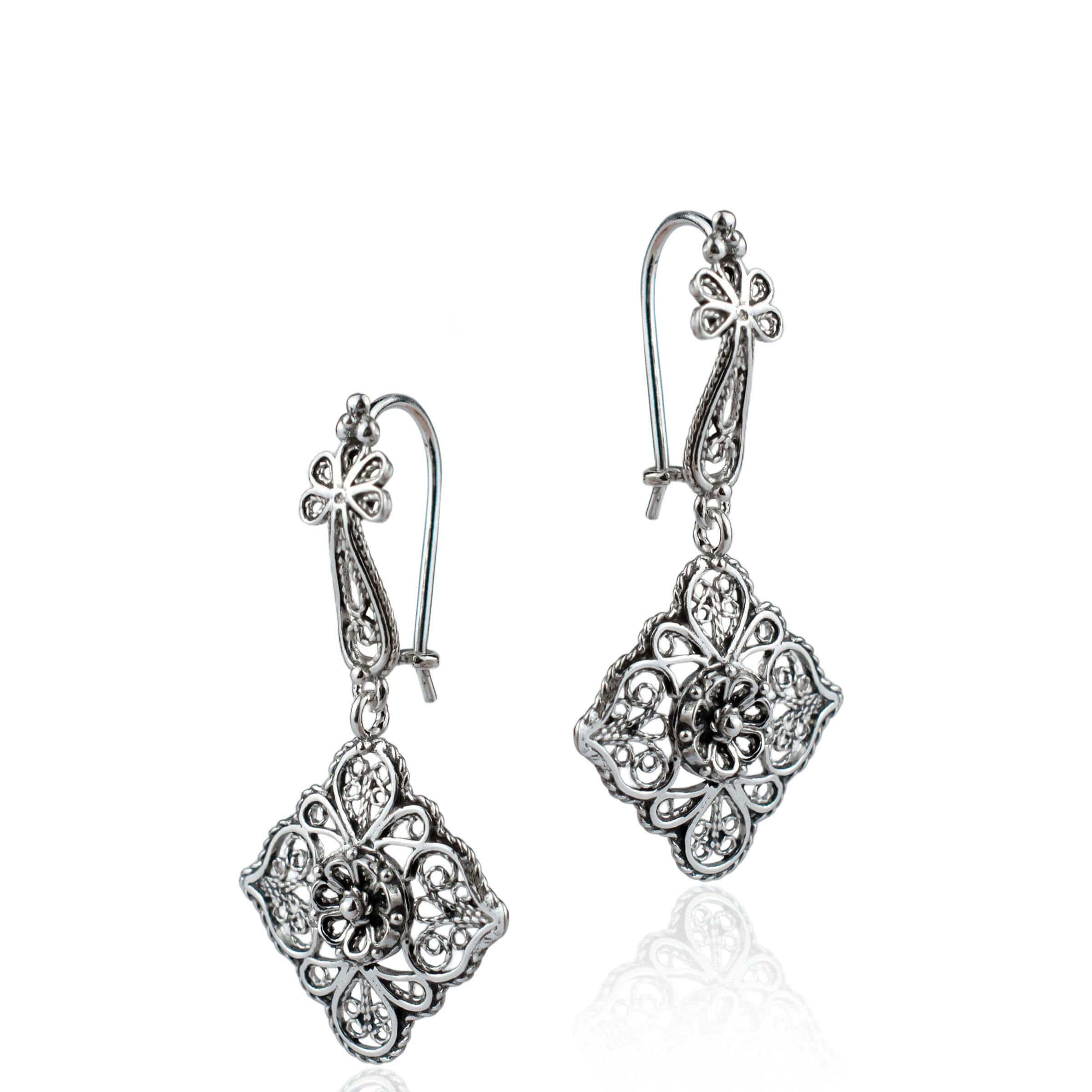Elegant sterling silver dangle drop earrings featuring intricate filigree flower design, showcasing craftsmanship and sophistication.