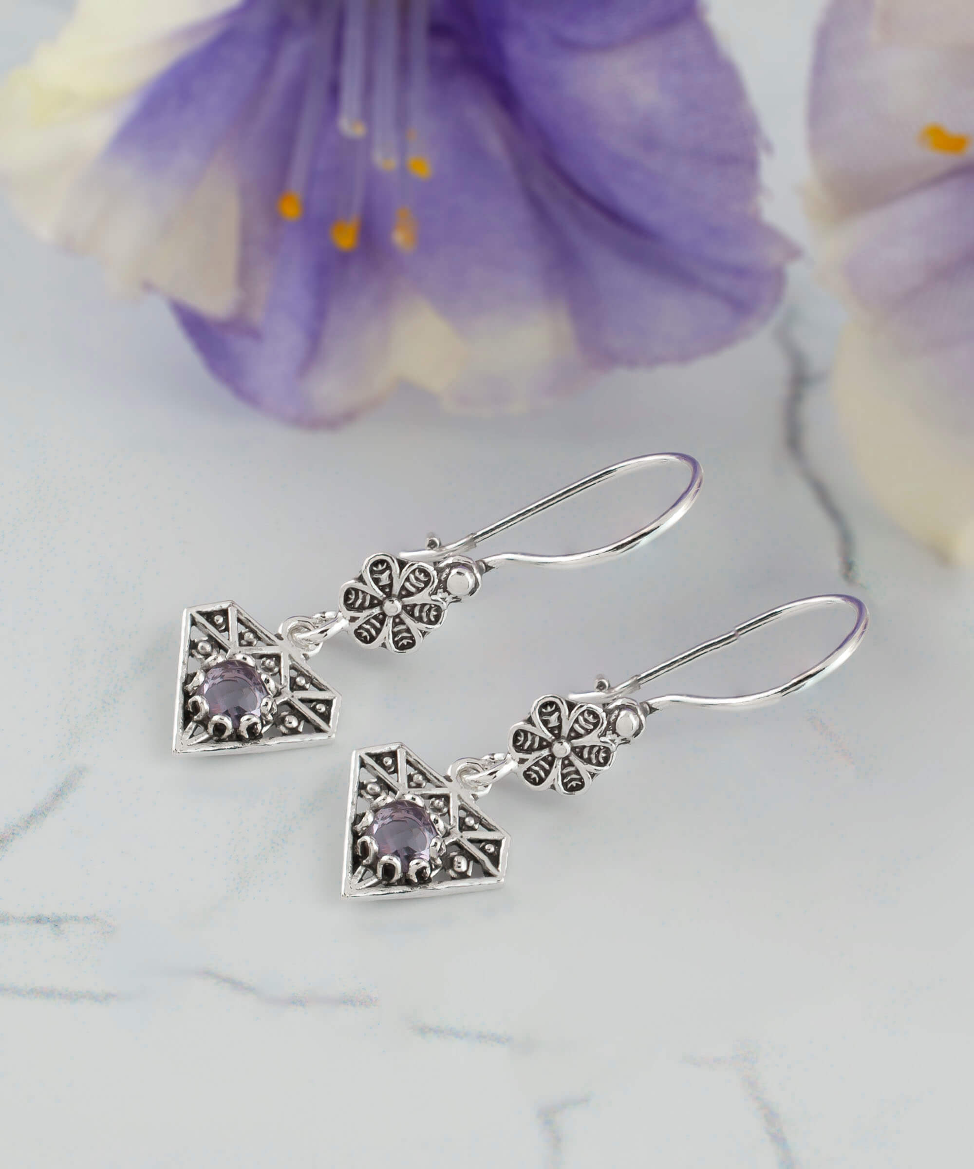 Elegant sterling silver dangle earrings featuring filigree design and colorful faceted gemstones including Amethyst, Blue Topaz, Blue Quartz, and Citrine.