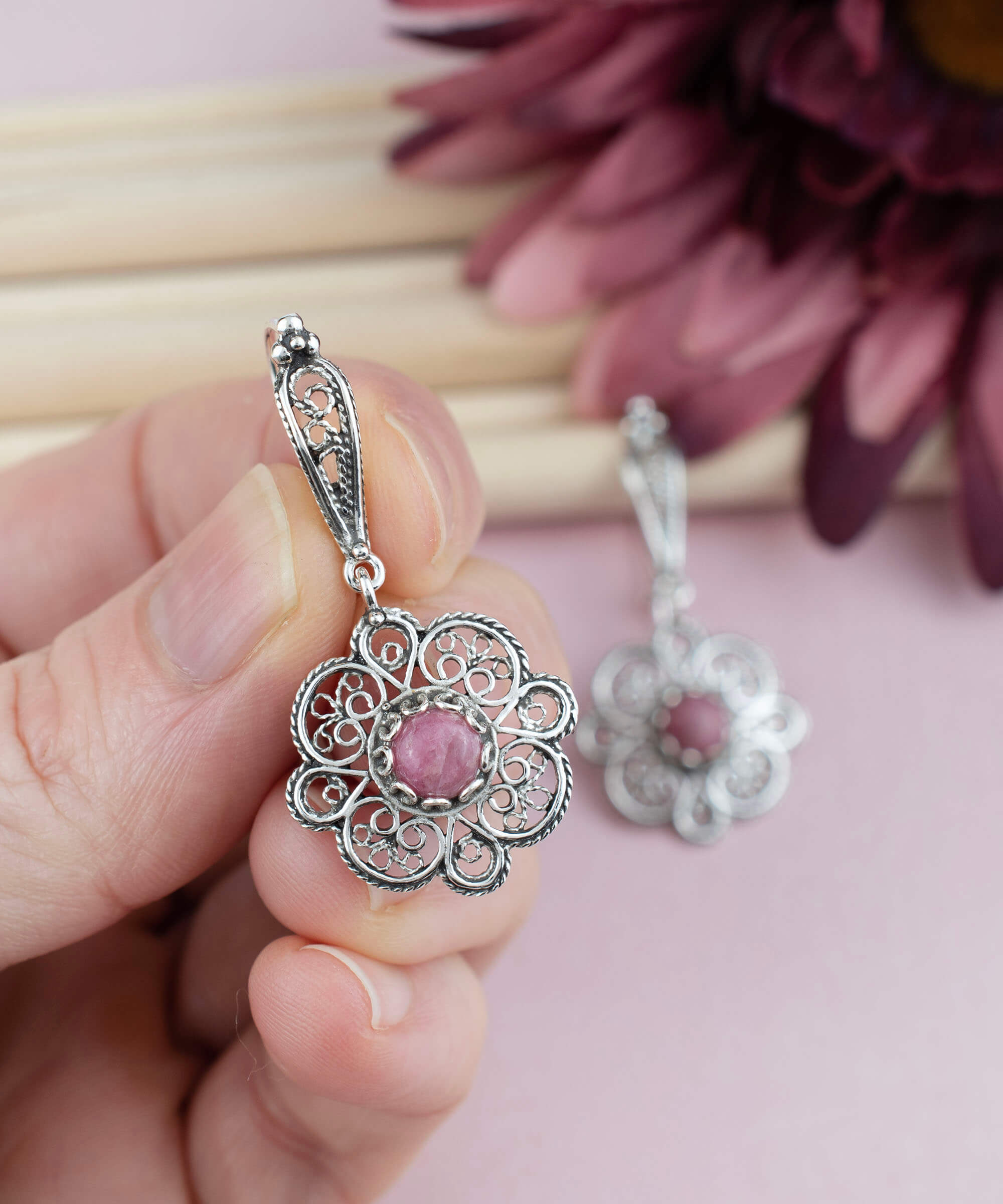 Handmade 925 sterling silver dangle drop earrings featuring intricate filigree art and a stunning Rhodonite gemstone.