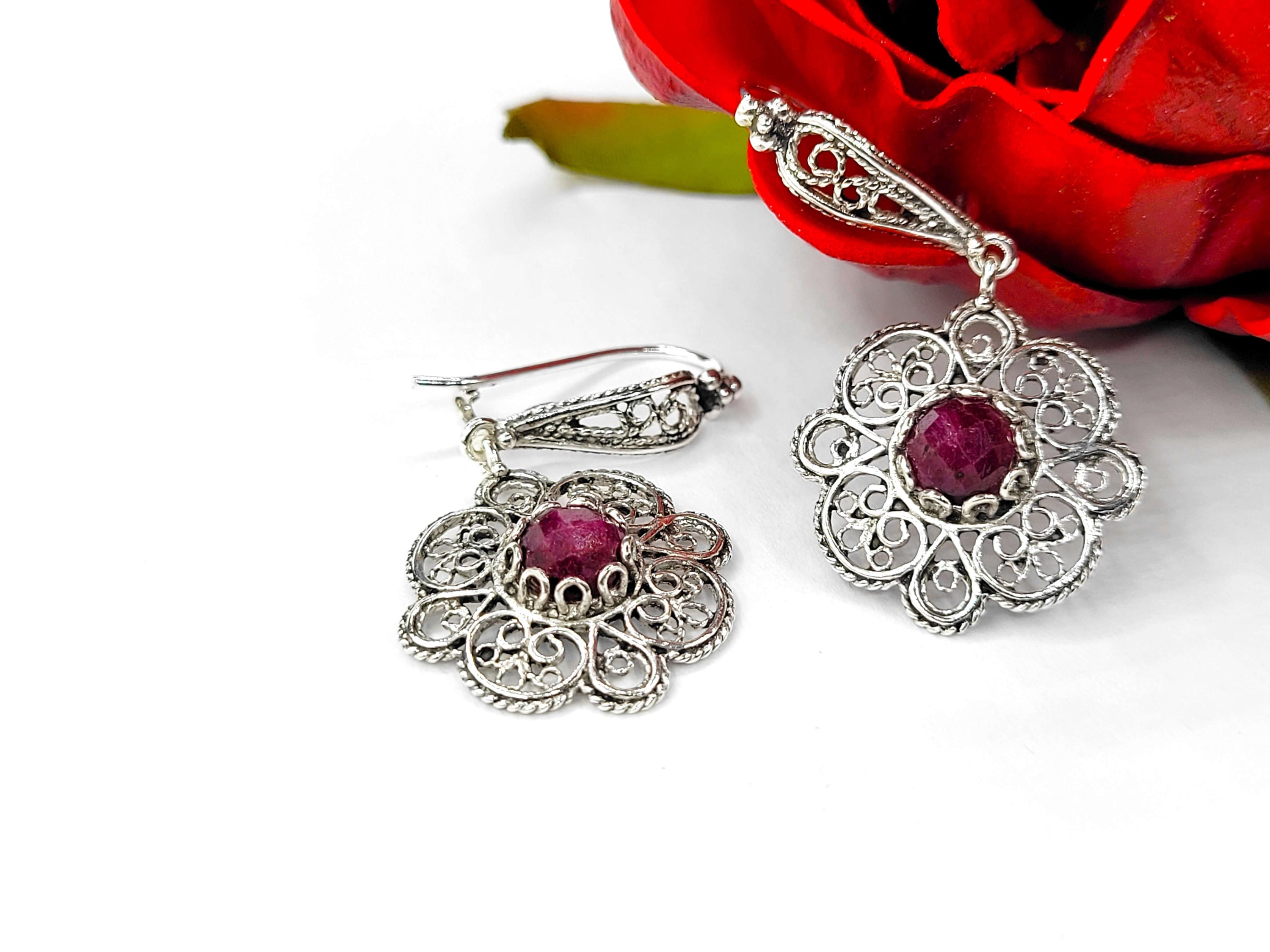 Handmade 925 sterling silver dangle drop earrings featuring intricate filigree art and ruby corundum gemstone in a sun figure design.
