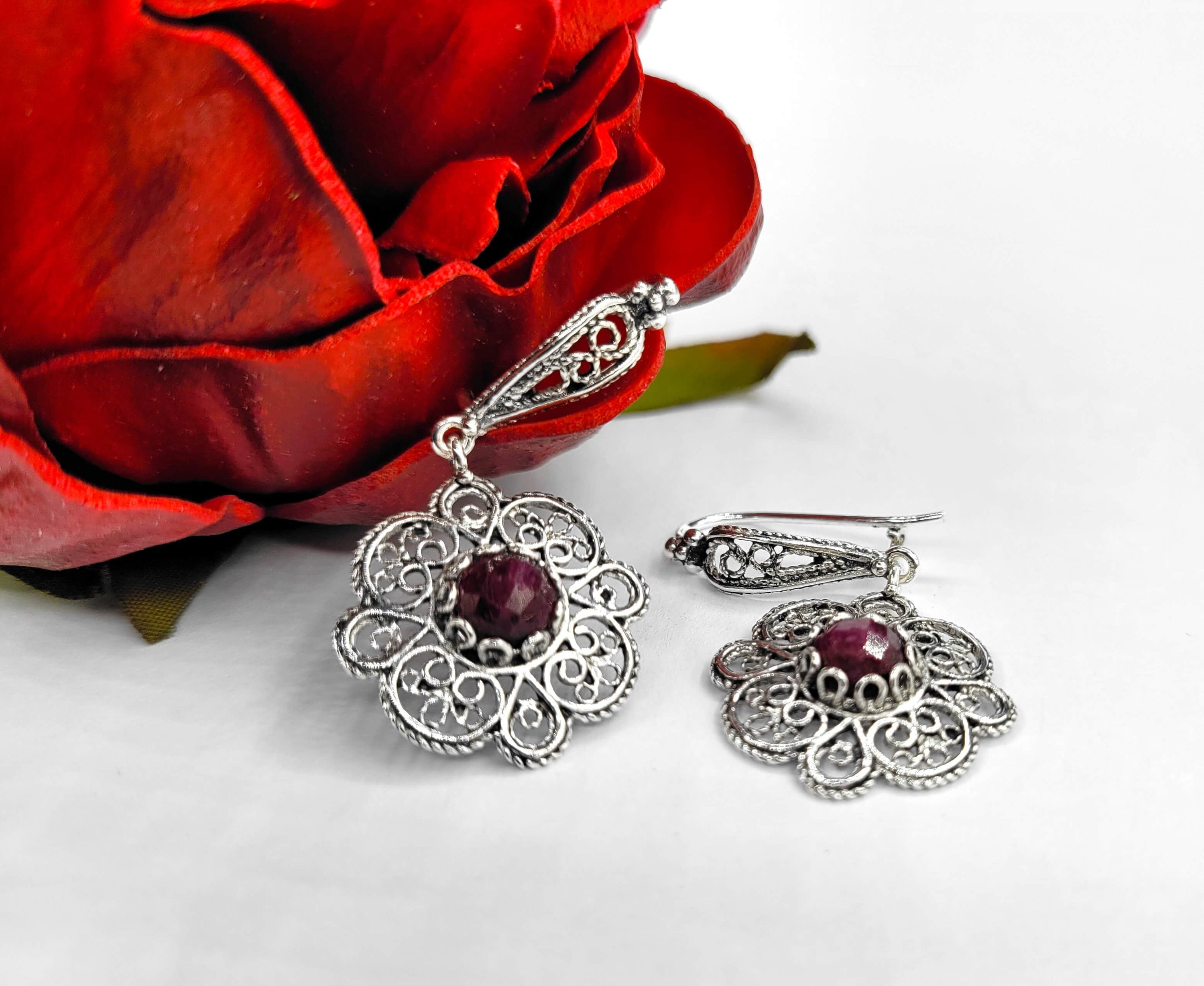 Handmade 925 sterling silver dangle drop earrings featuring intricate filigree art and ruby corundum gemstone in a sun figure design.