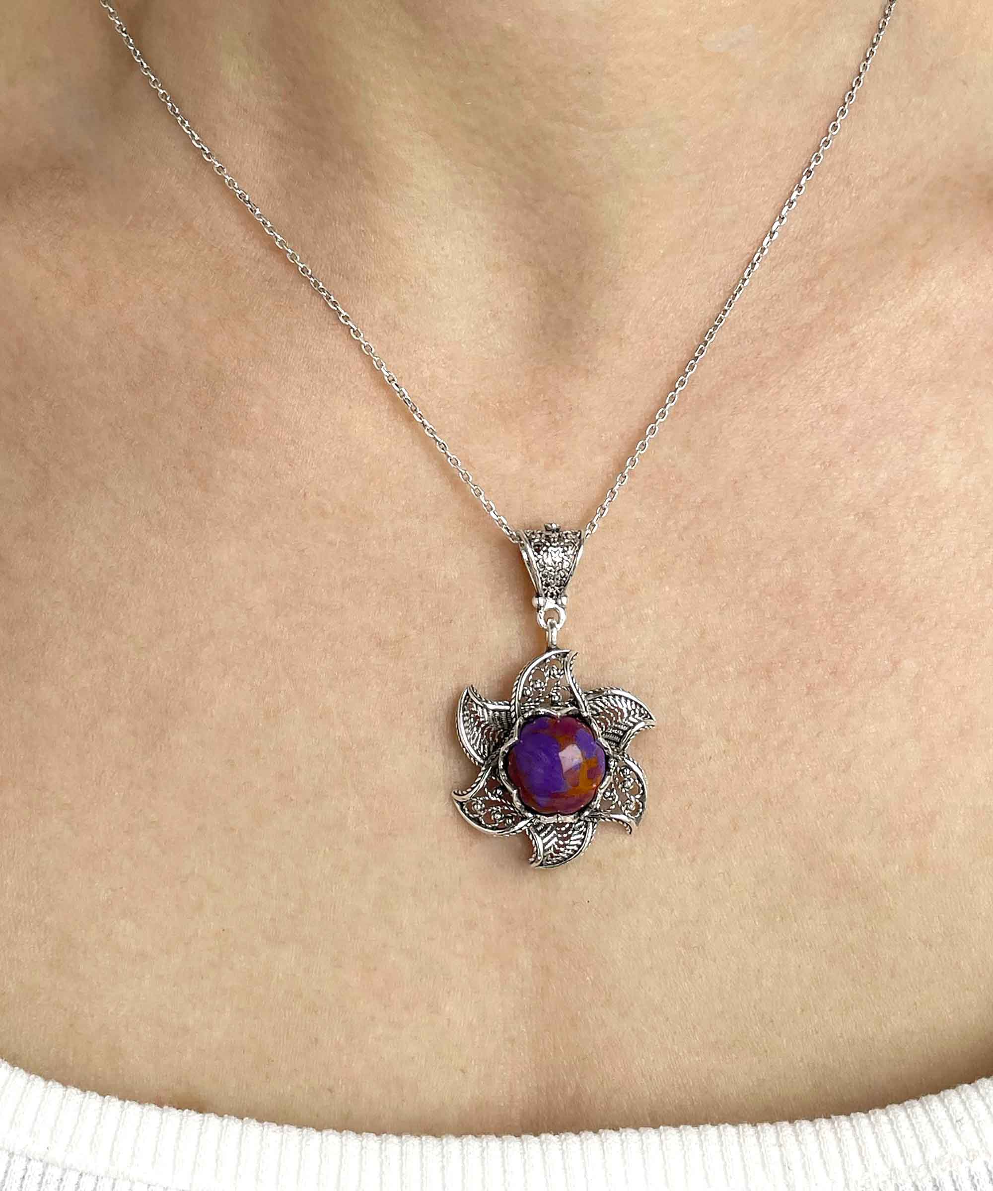 Sterling Silver Filigree necklace featuring a blossoming lotus flower pendant with a mojave turquoise gemstone at the center, elegantly displayed.