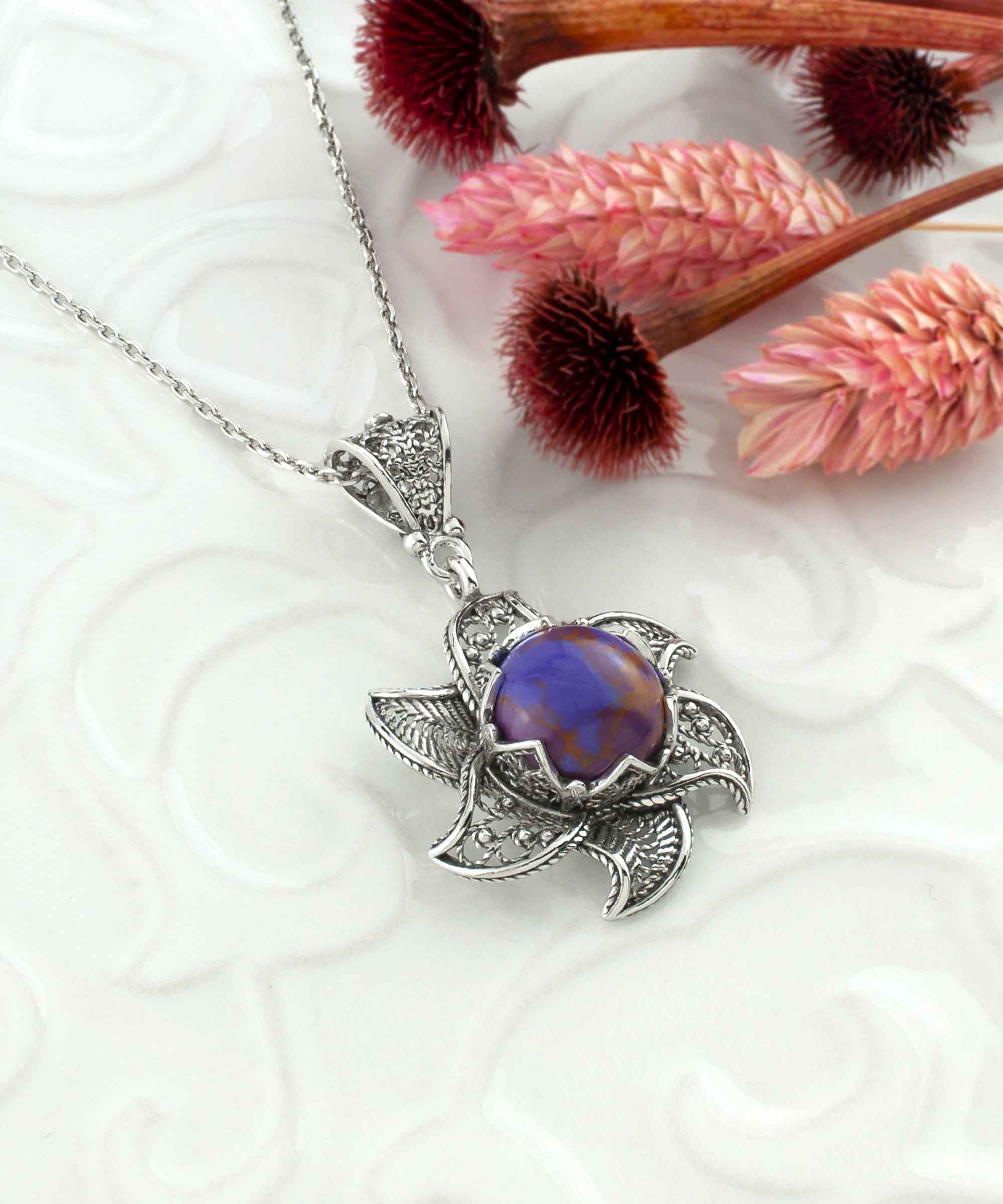 Sterling Silver Filigree necklace featuring a blossoming lotus flower pendant with a mojave turquoise gemstone at the center, elegantly displayed.