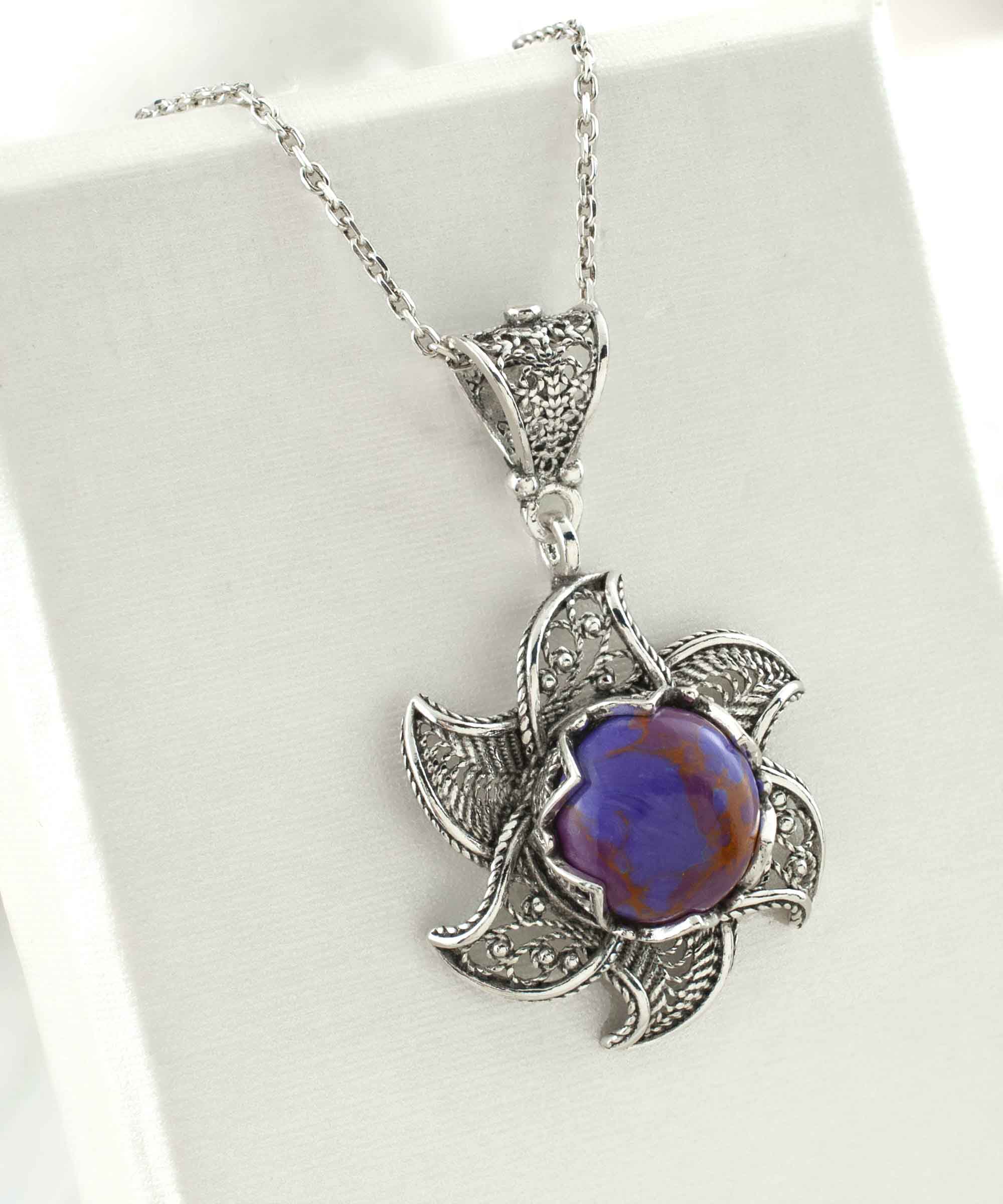 Sterling Silver Filigree necklace featuring a blossoming lotus flower pendant with a mojave turquoise gemstone at the center, elegantly displayed.