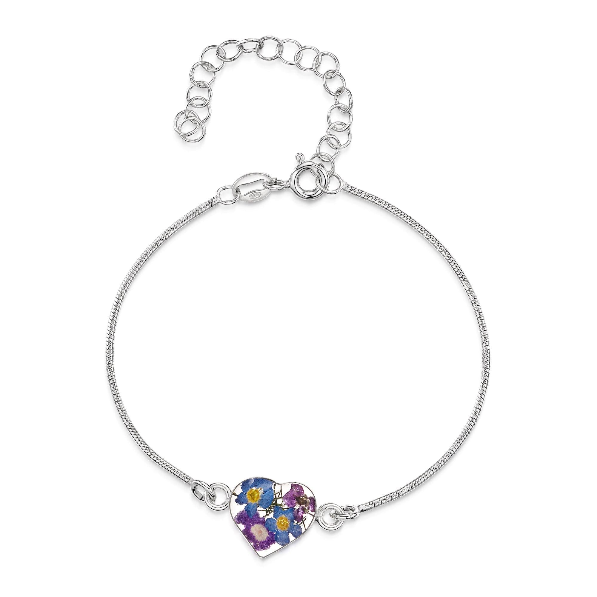 Sterling silver snake bracelet featuring a heart charm with real flowers set in resin, showcasing a delicate and elegant design.