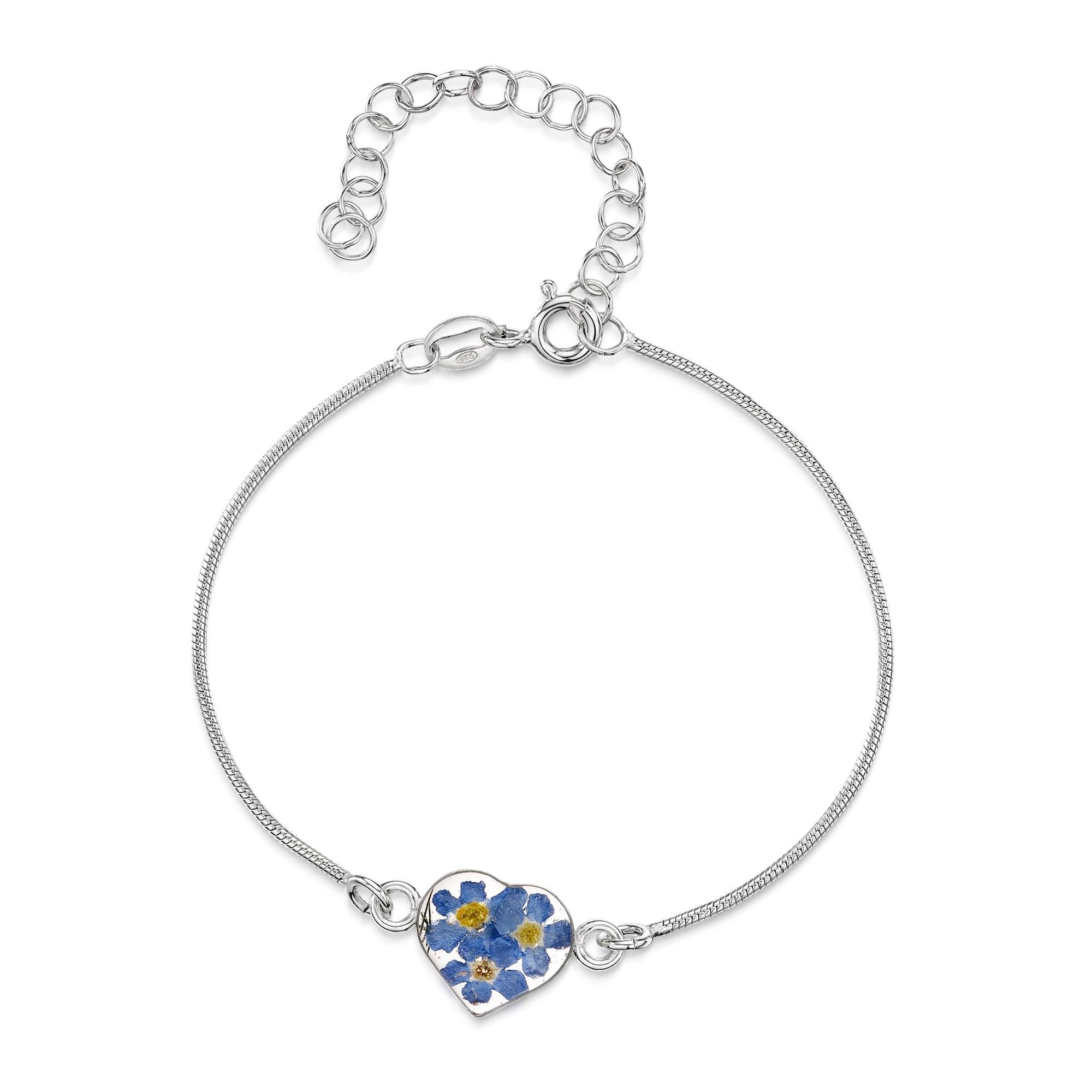 Sterling silver snake chain bracelet with a handmade charm featuring real blue forget-me-not flowers set in resin, elegantly displayed in a gift box.