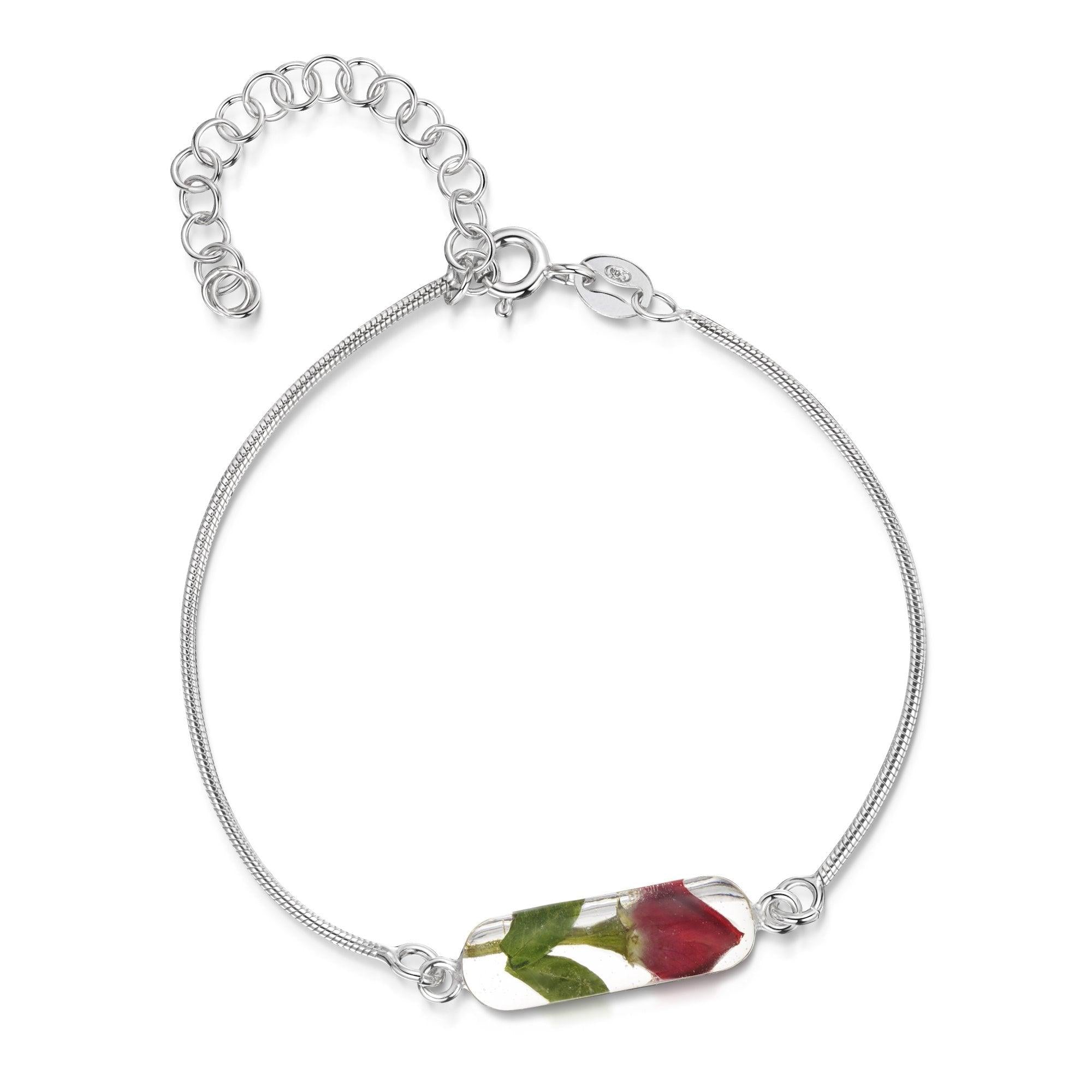 Sterling silver snake chain bracelet featuring a delicate rose bud charm, elegantly displayed in a gift box.