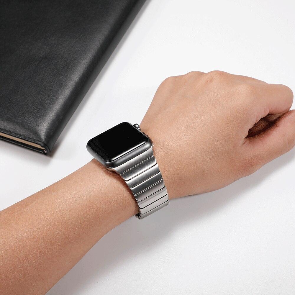Stainless steel strap for Apple Watch in various colors, showcasing its elegant design and butterfly buckle clasp.