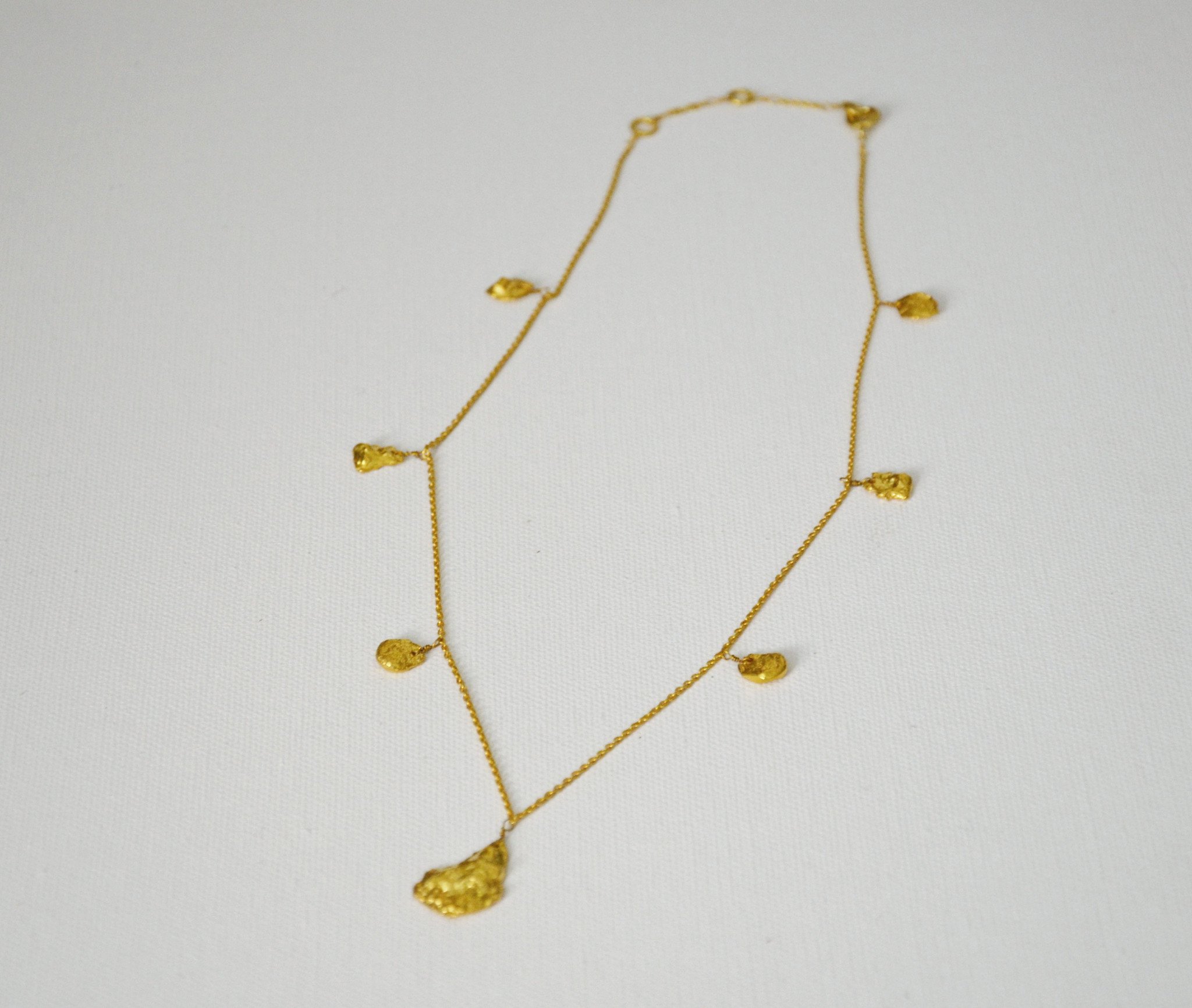 Studio 54 Gold Nugget necklace featuring chunky gold nuggets on a delicate chain, showcasing a 70's glam style.