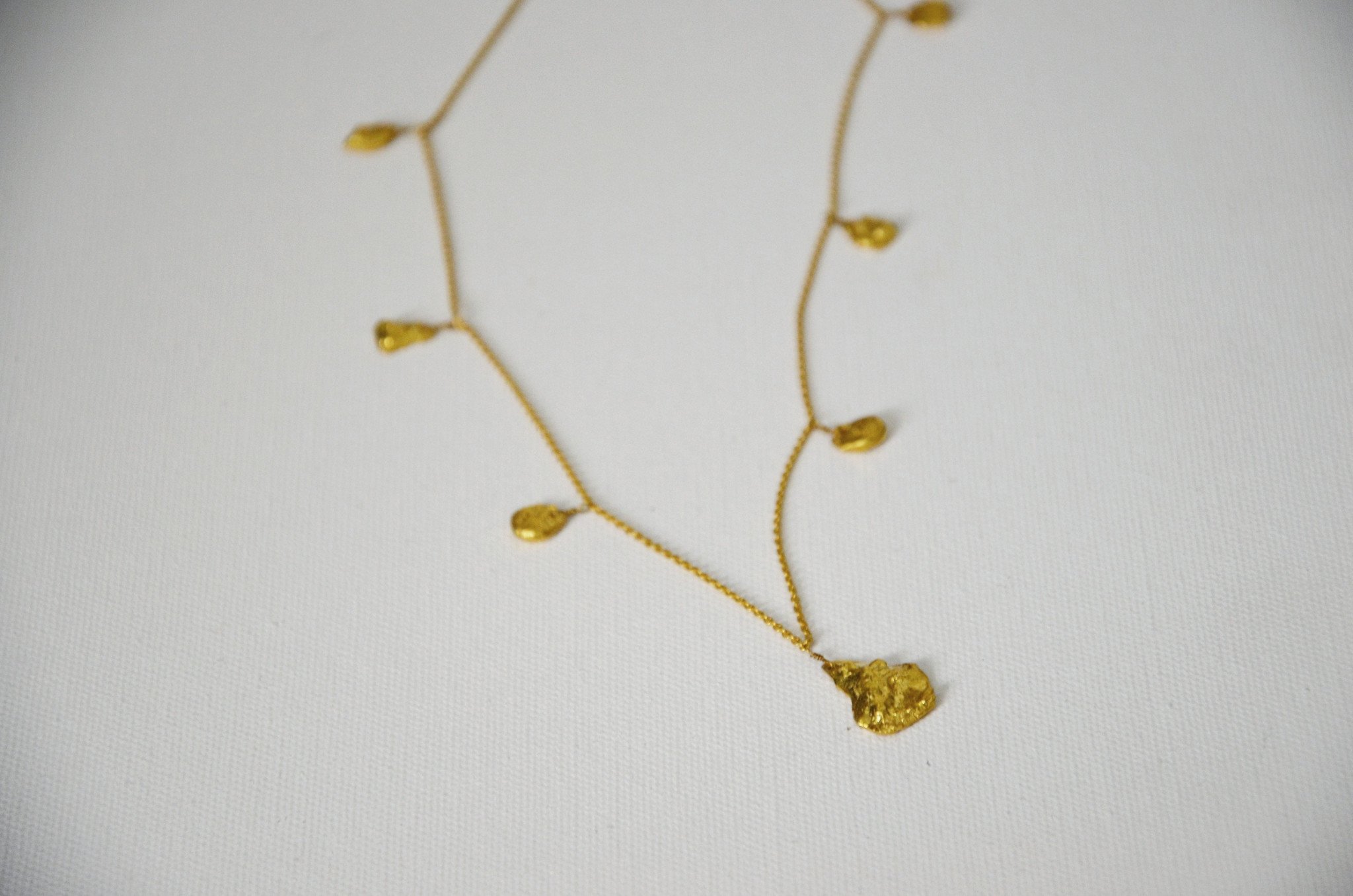 Studio 54 Gold Nugget necklace featuring chunky gold nuggets on a delicate chain, showcasing a 70's glam style.