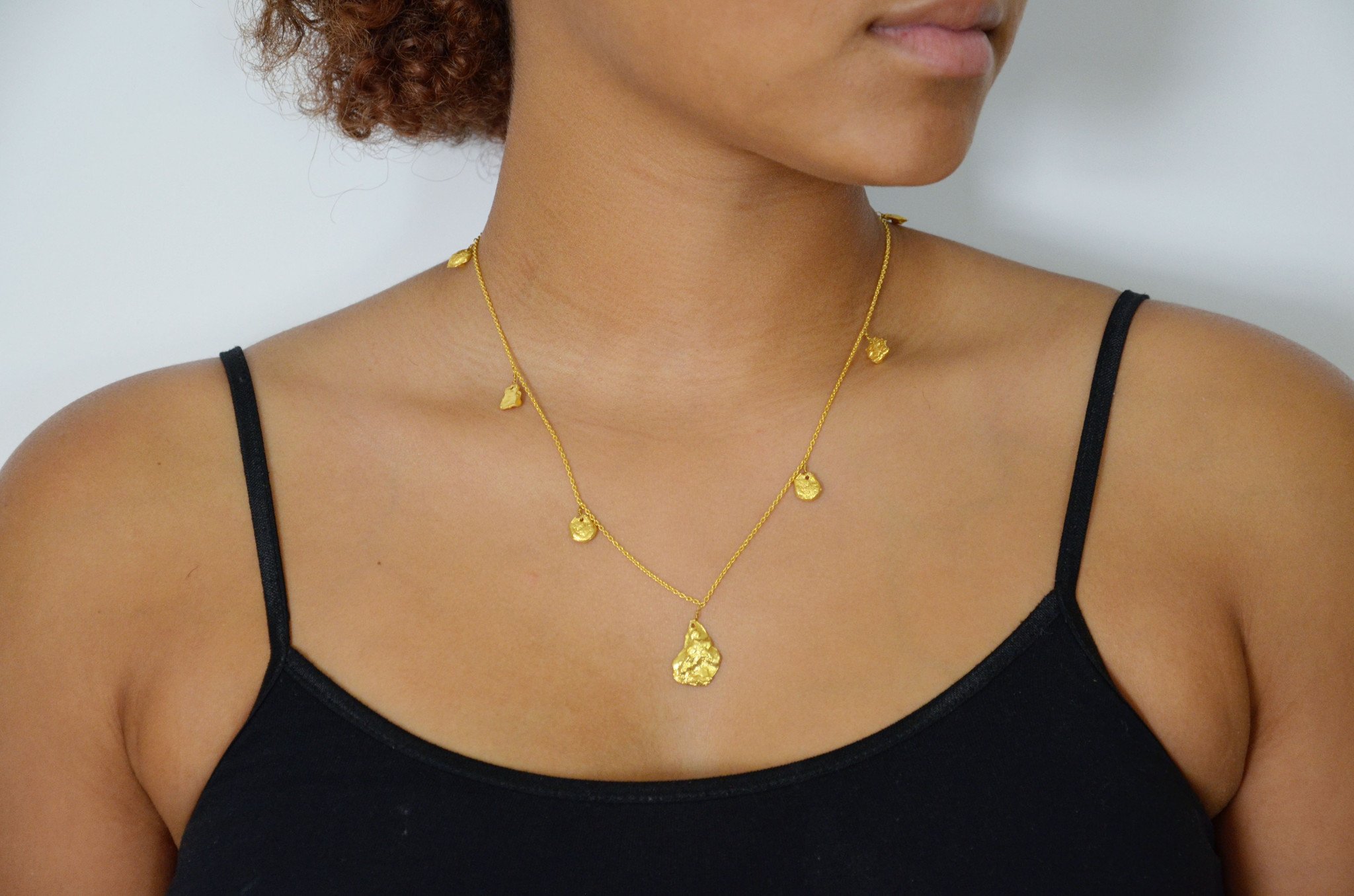 Studio 54 Gold Nugget necklace featuring chunky gold nuggets on a delicate chain, showcasing a 70's glam style.