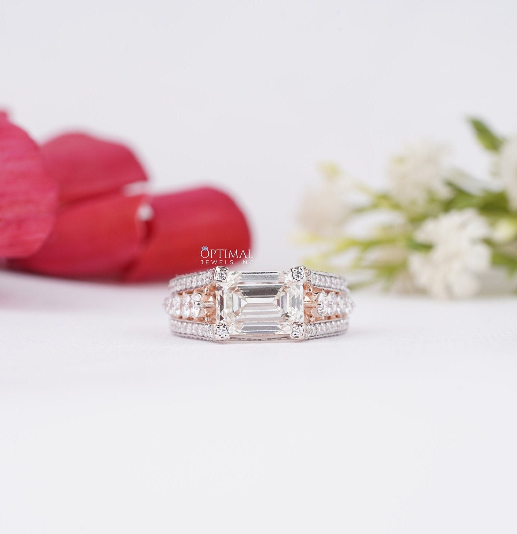 Stunning Art Deco Inspired Ring featuring a 1.50 CT emerald cut lab-grown diamond center stone and round cut side stones, set in rose gold.