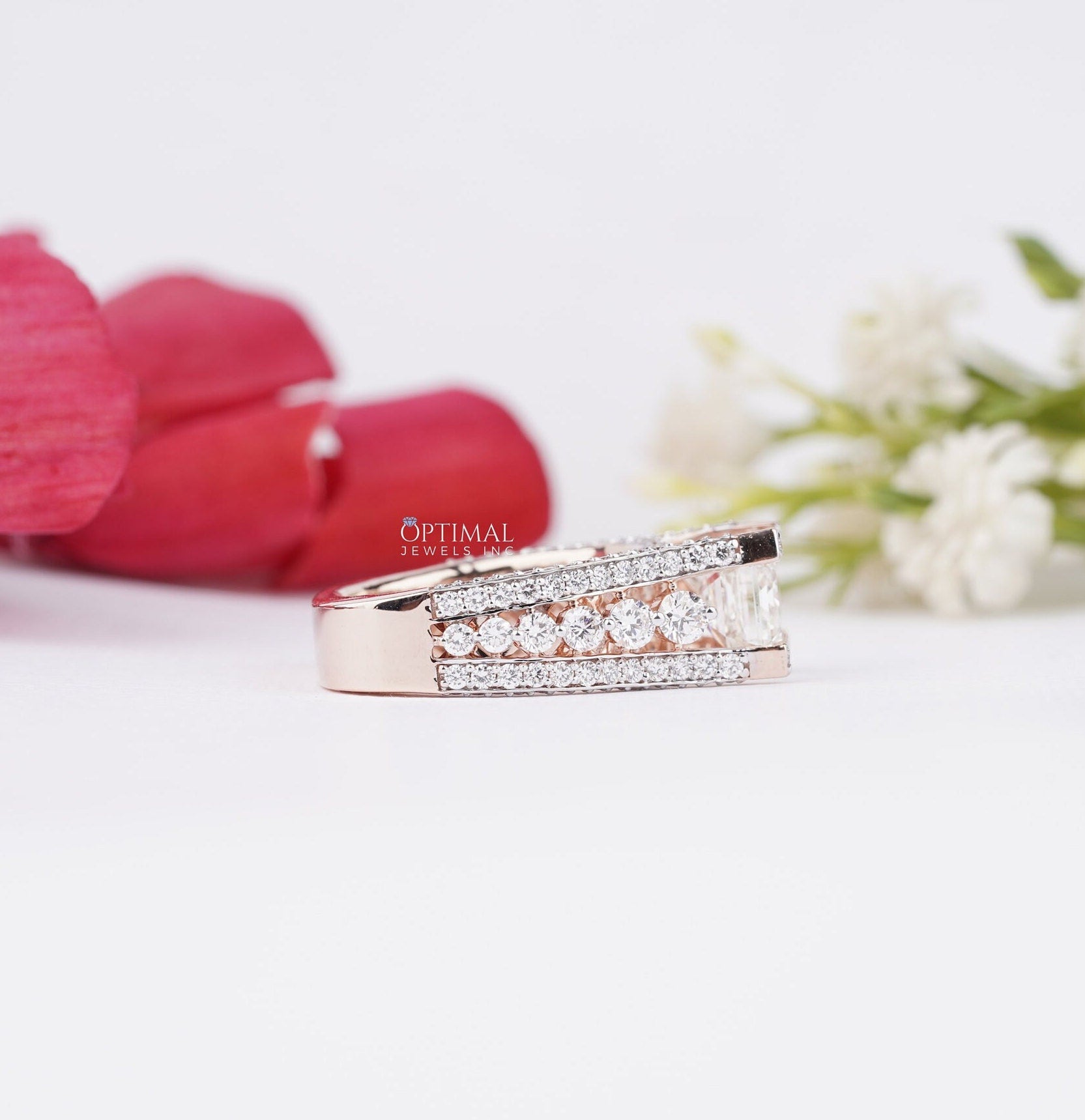 Stunning Art Deco Inspired Ring featuring a 1.50 CT emerald cut lab-grown diamond center stone and round cut side stones, set in rose gold.