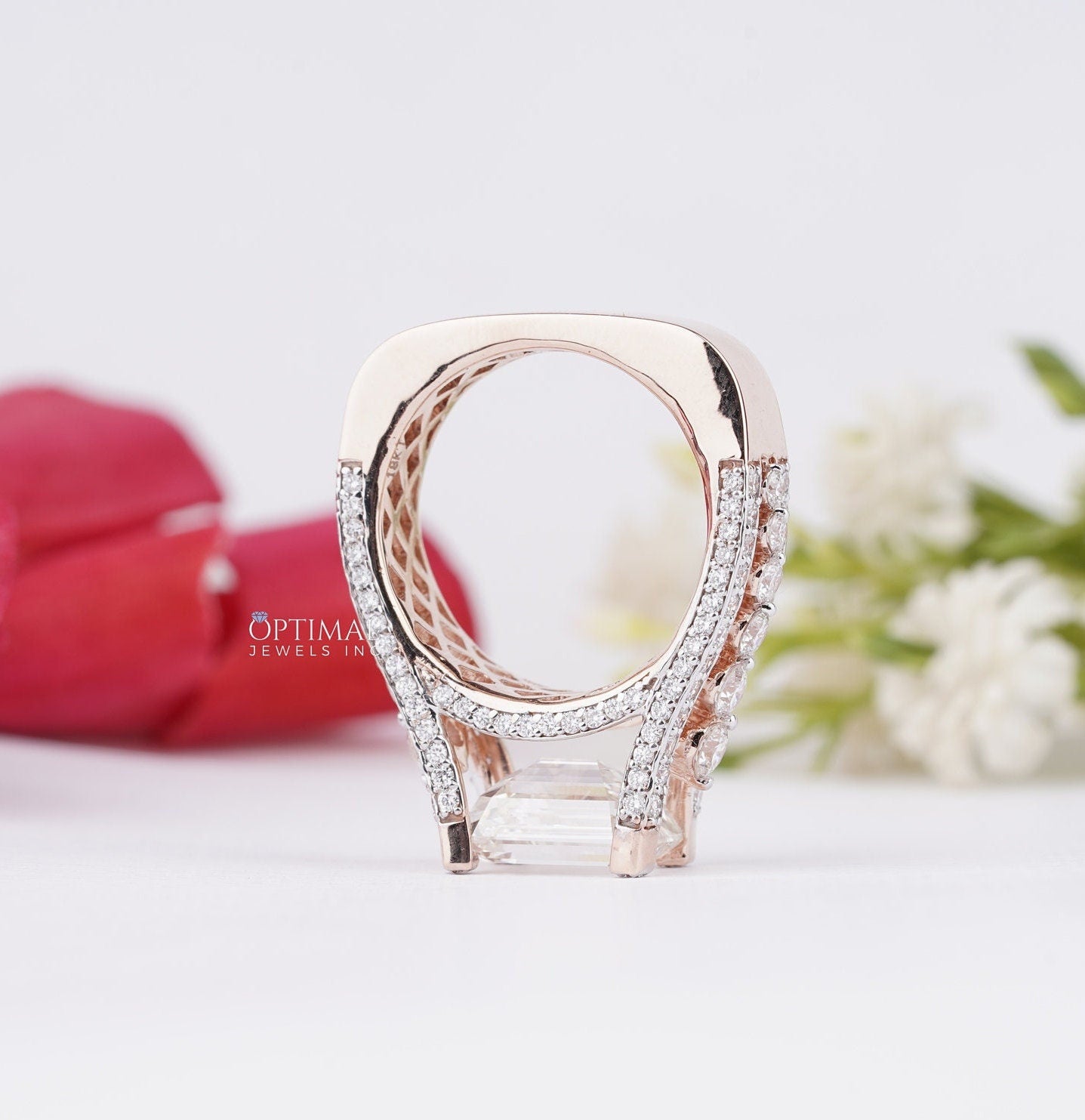 Stunning Art Deco Inspired Ring featuring a 1.50 CT emerald cut lab-grown diamond center stone and round cut side stones, set in rose gold.