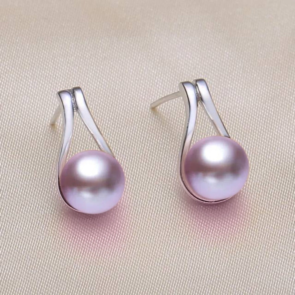 A pair of stunning French hook drop earrings featuring genuine freshwater pearls in white, pink, and purple colors, elegantly displayed.