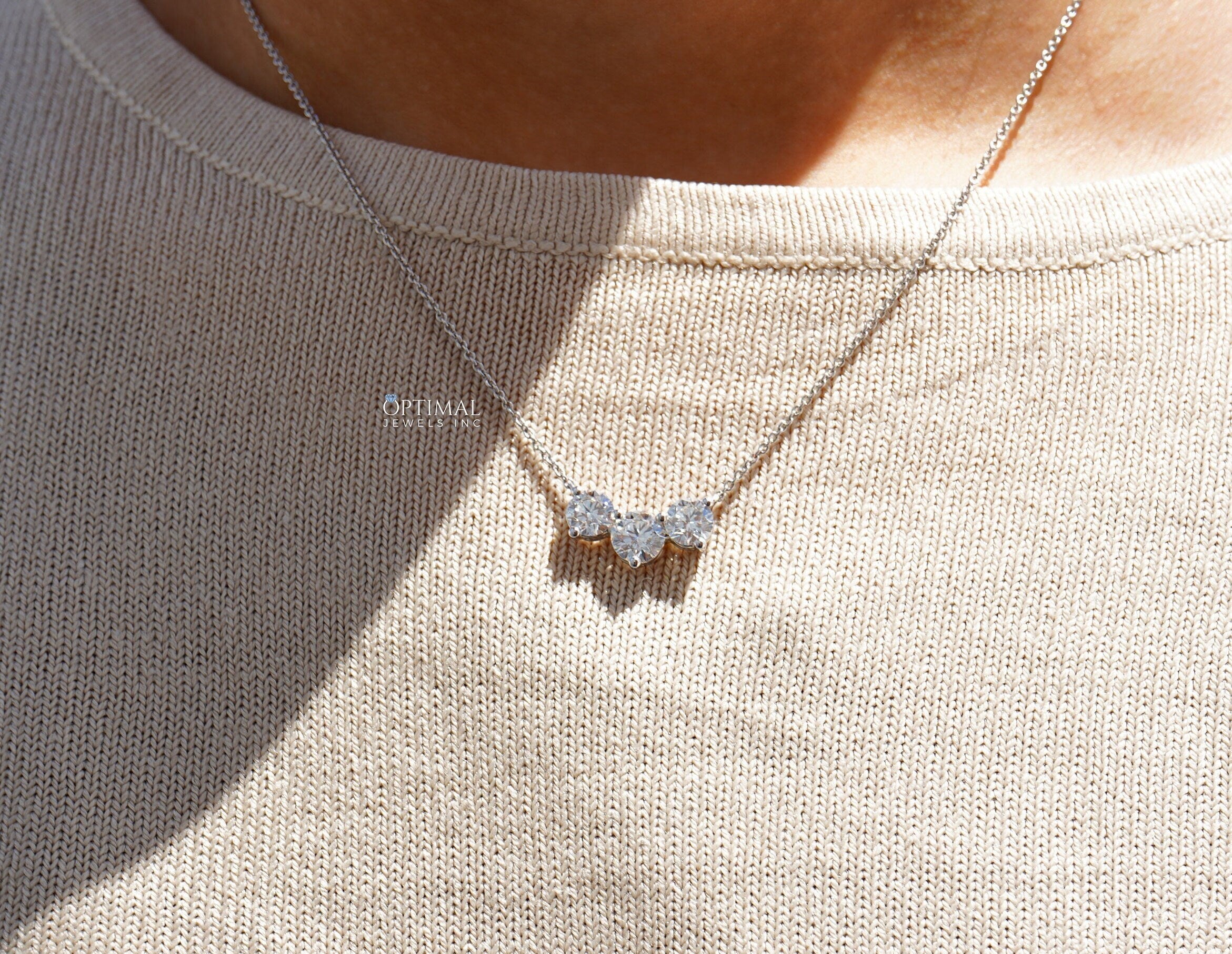 Stunning round cut lab grown diamond necklace with three stone pendant on an 18-inch white gold chain, showcasing brilliance and elegance.