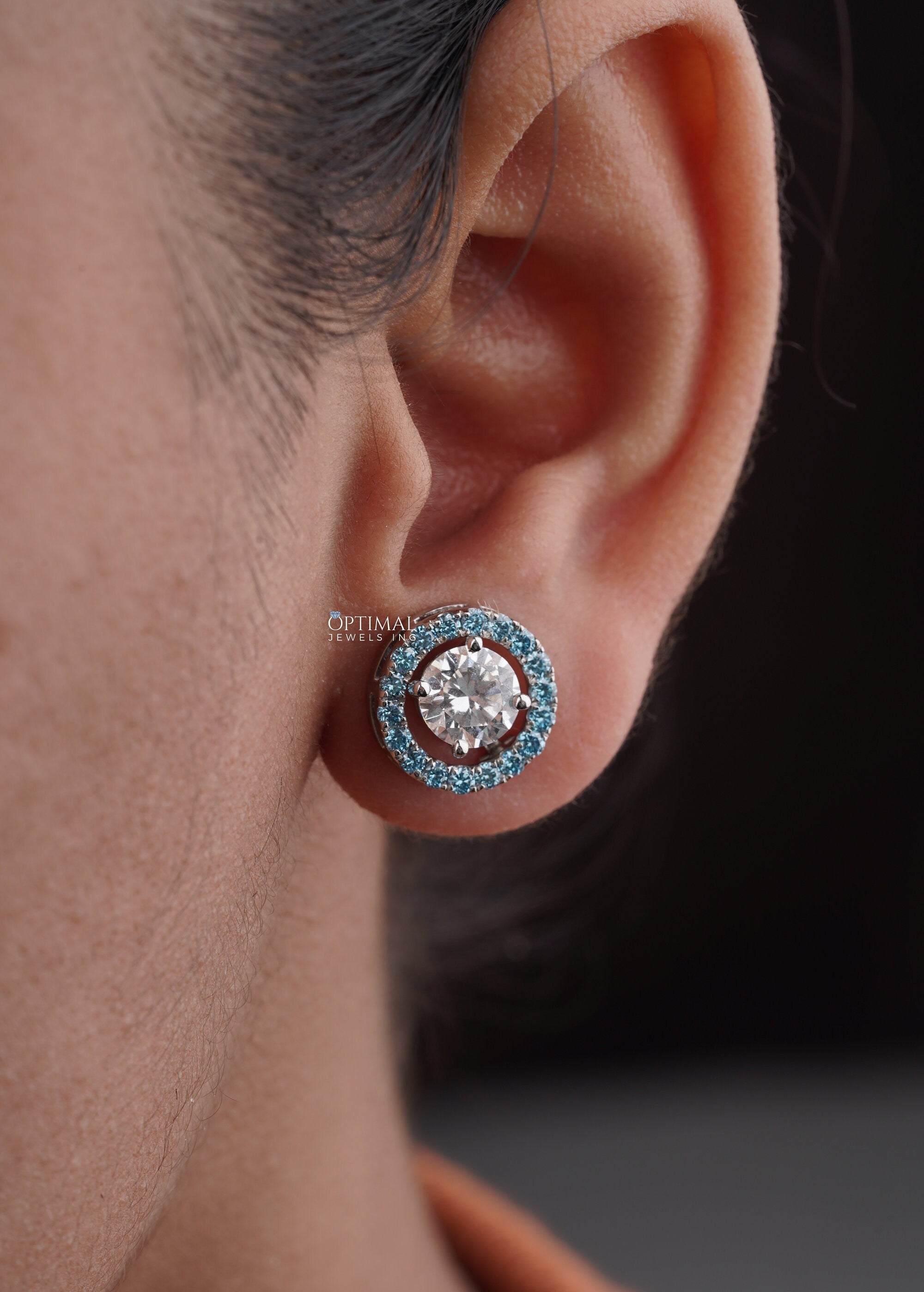 Stunning Round Halo Stud Earring featuring 2.44 Ctw Blue Sapphire in a pave setting, crafted in white gold with lab-grown diamonds.