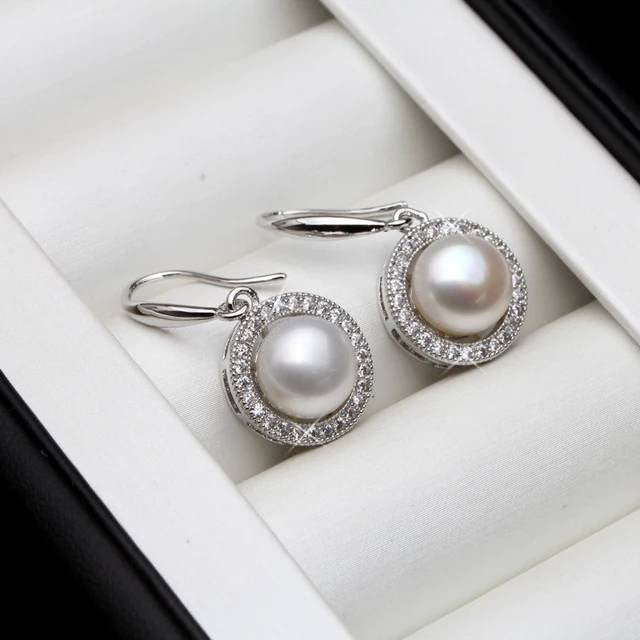 A pair of stunning drop earrings featuring genuine freshwater pearls in various colors, adorned with simulated diamonds for added elegance.