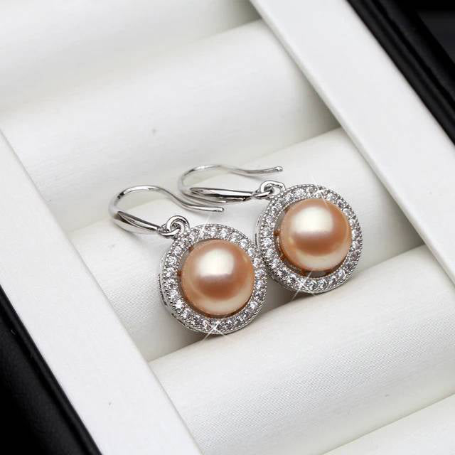 A pair of stunning drop earrings featuring genuine freshwater pearls in various colors, adorned with simulated diamonds for added elegance.